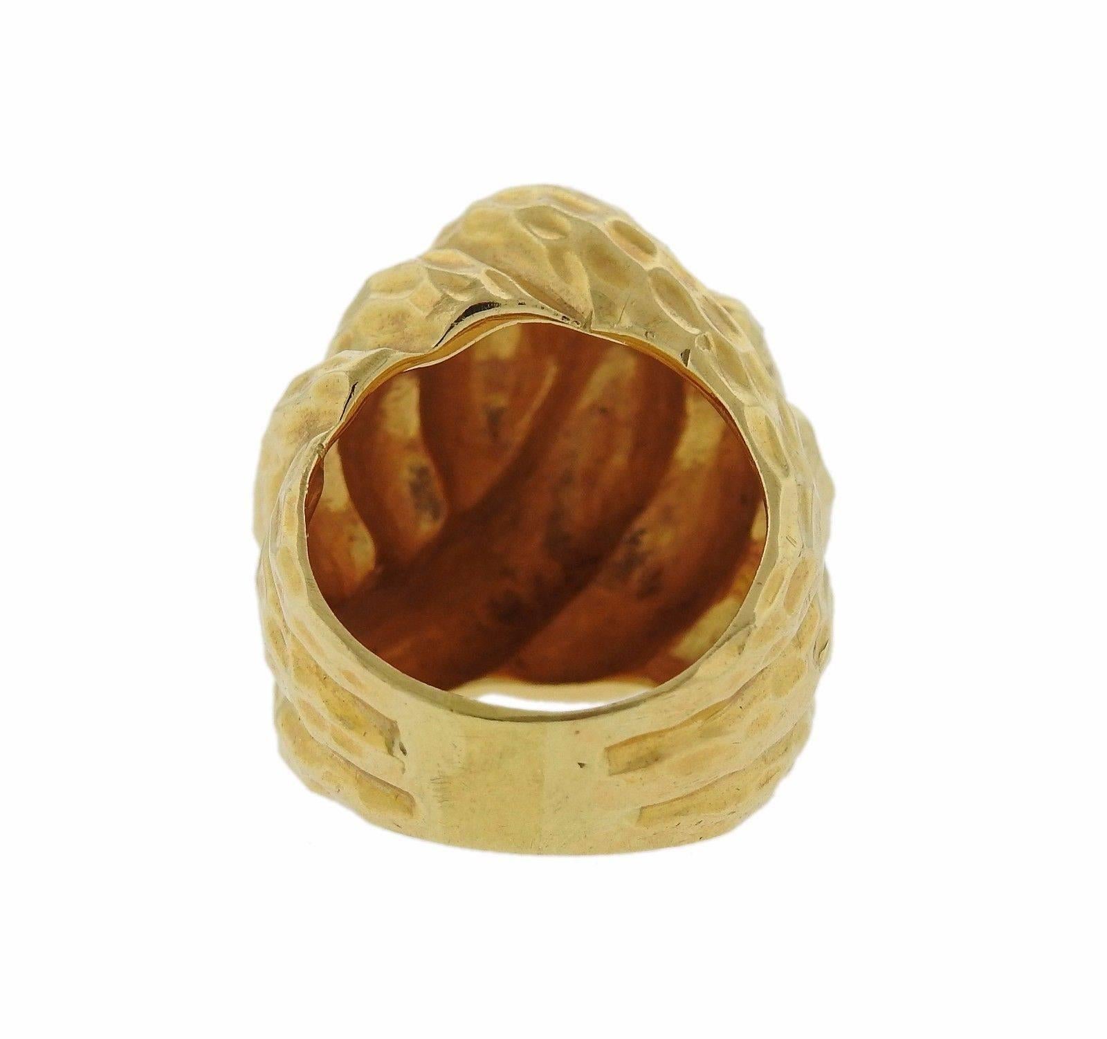 An 18k gold hammered finish dome ring.  The ring is a size 7.  The top of the ring is 22mm x 23mm and sits 13mm from the finger.  The weight of the piece is 24.9 grams.