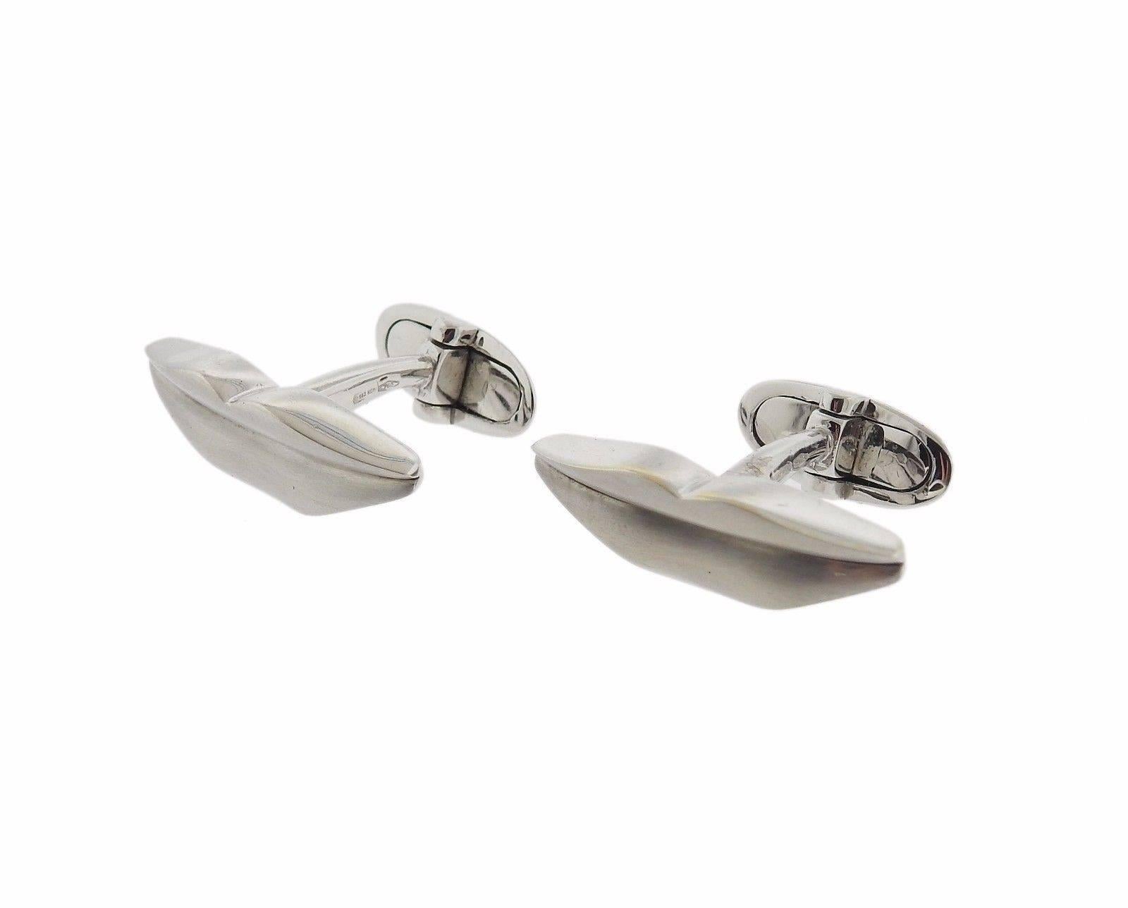 A pair of 18k white gold cufflinks depicting lips.  The cufflinks measure 25mm x 8mm and weigh 14.7 grams.  Marked: Enigma,  750 , 983 ROMA.  Current retail is $3500.