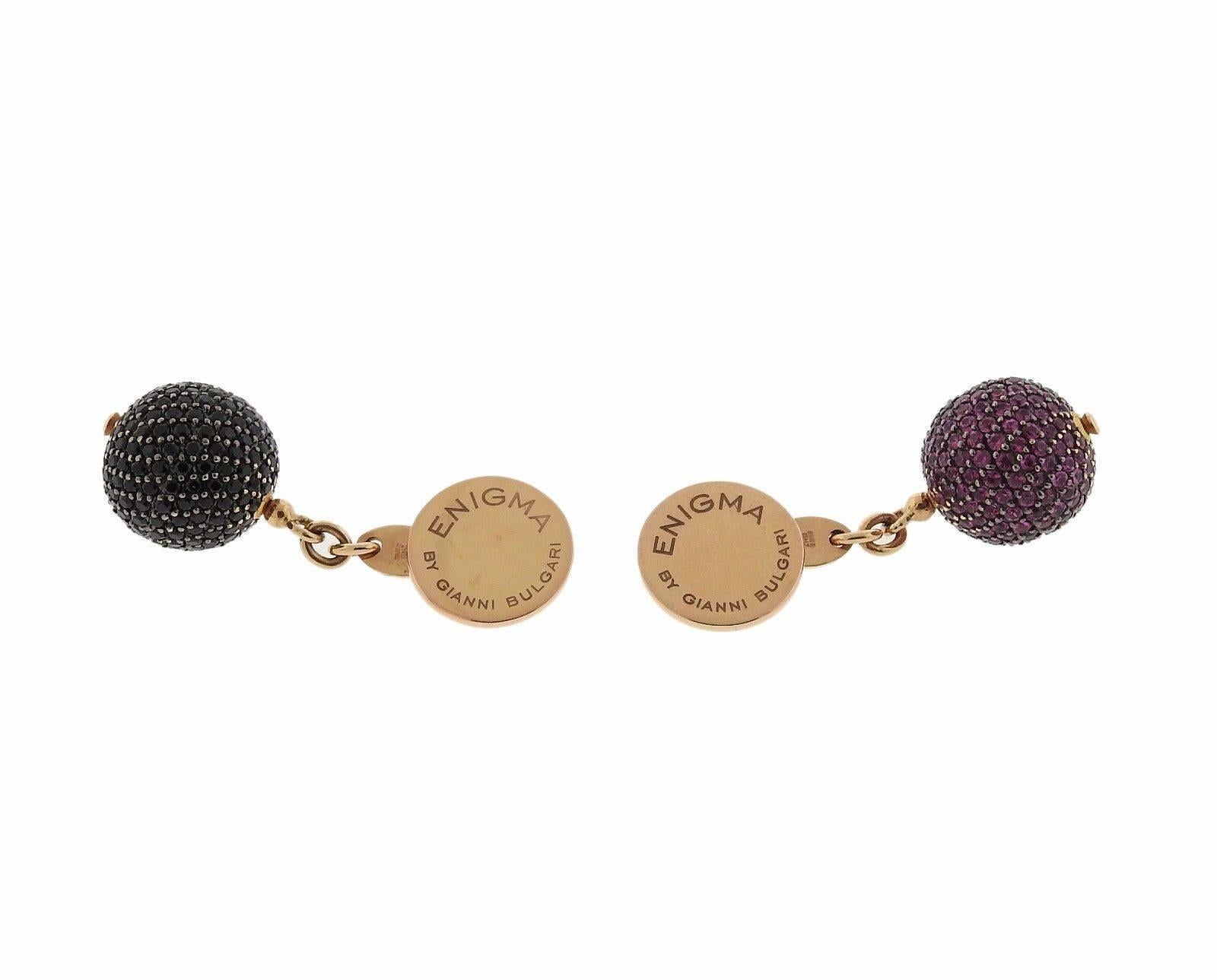 A pair of 18k gold cufflinks set with black spinel and pink sapphires.  The cufflnks measure 12mm and weigh 12.5 grams.  Marked: Enigma by Gianni Bulgari ,  750 , made in Italy, 1498 AR.  The retail for this pair is $4100.