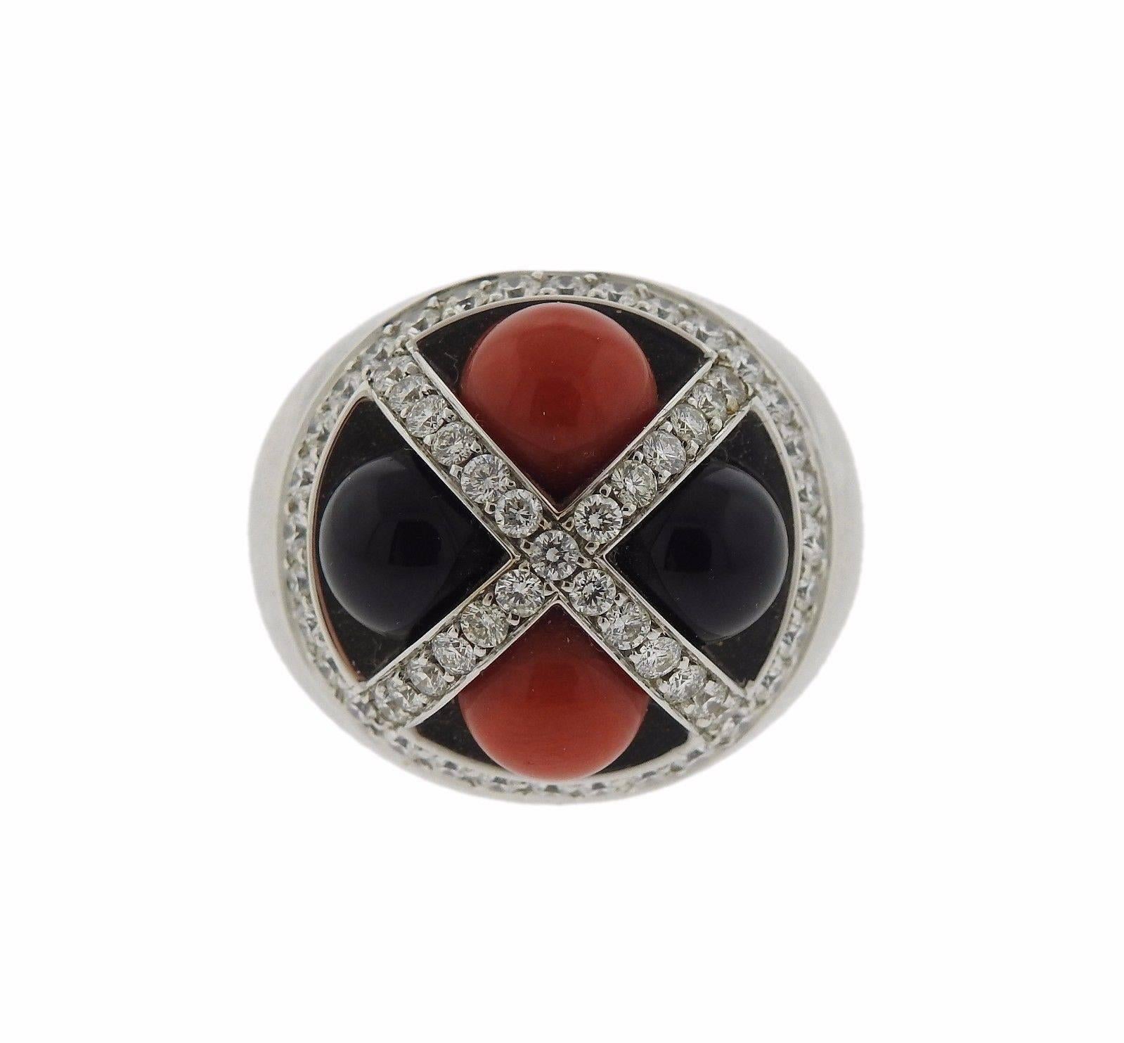 An 18k white gold ring set with 7.3mm coral and onyx stones.  The ring is a size 6 1/2 and the top is 20mm in diameter.  The weight of the piece is 23.2 grams.  Marked: Enigma, made in Italy , 750.  The retail is $10800.