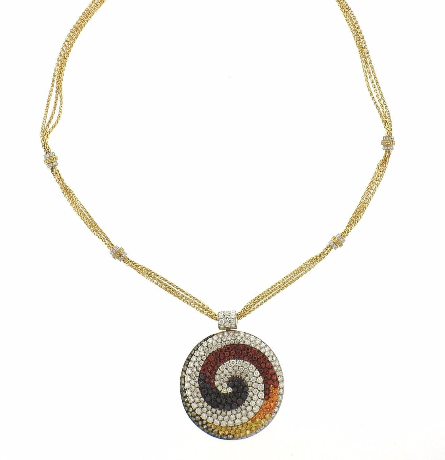 An 18k gold necklace with circle pendant, crafted by Valente, featuring multi color sapphires and approximately 3.50ctw in G/VS diamonds in a swirl design. Entire length is 21