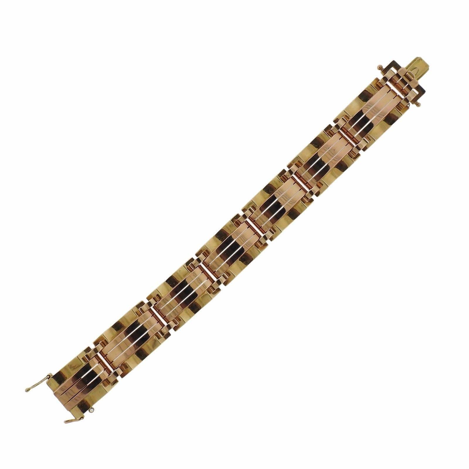 A 14k yellow and rose gold bracelet.  The bracelet is 7 1/8" long and 18mm wide.  The weight of the piece is 61.1 grams.  Marked with European gold assay marks.