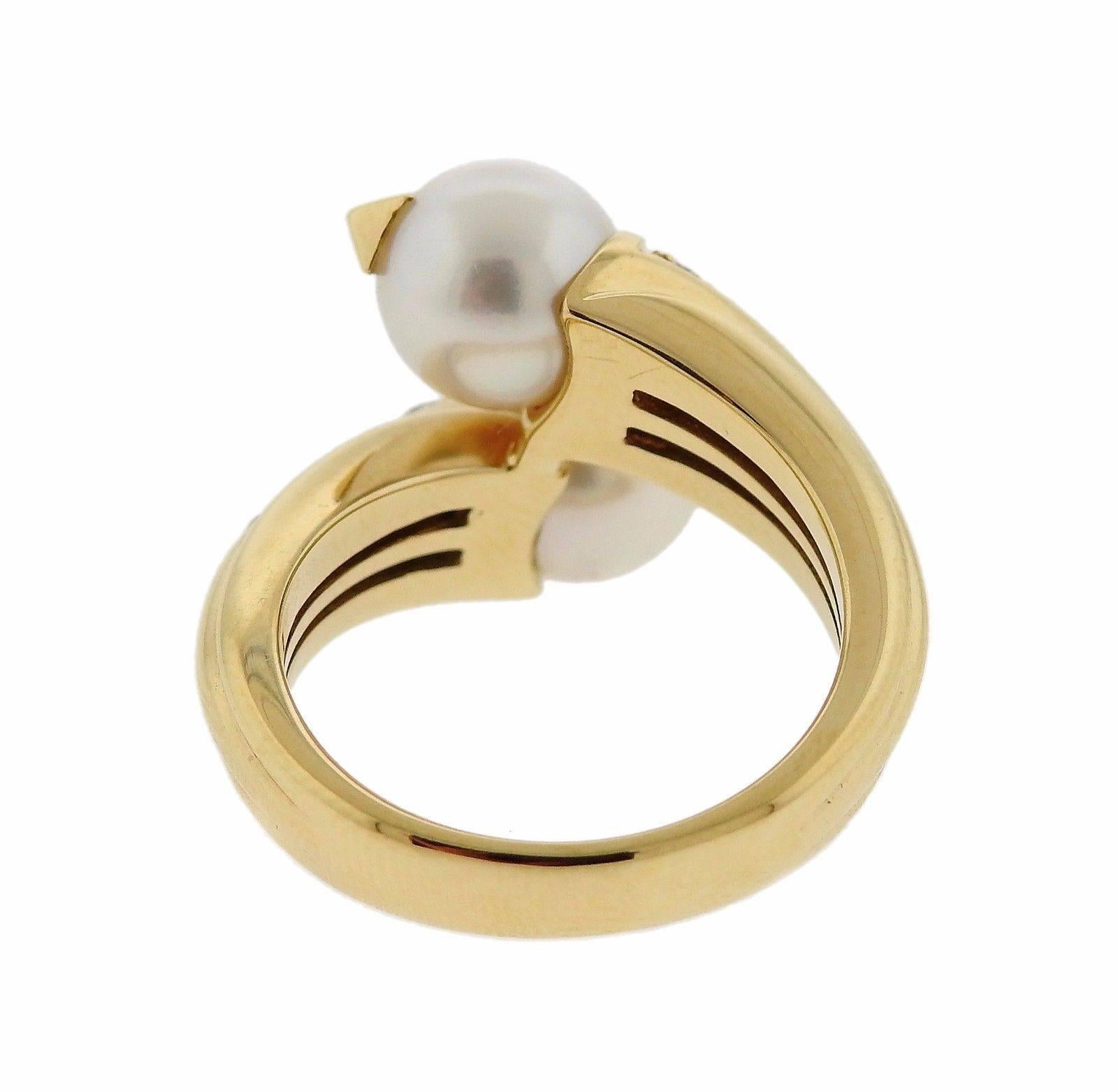 An 18k gold bypass ring by set with 7.4mm pearls and approximately 0.16ctw of G/VS diamonds.  The ring is a size 5.5 and the ring top is 16mm wide.  The weight of the piece is 8.3 grams.  Marked: Bvlgari, 750, Italian mark.