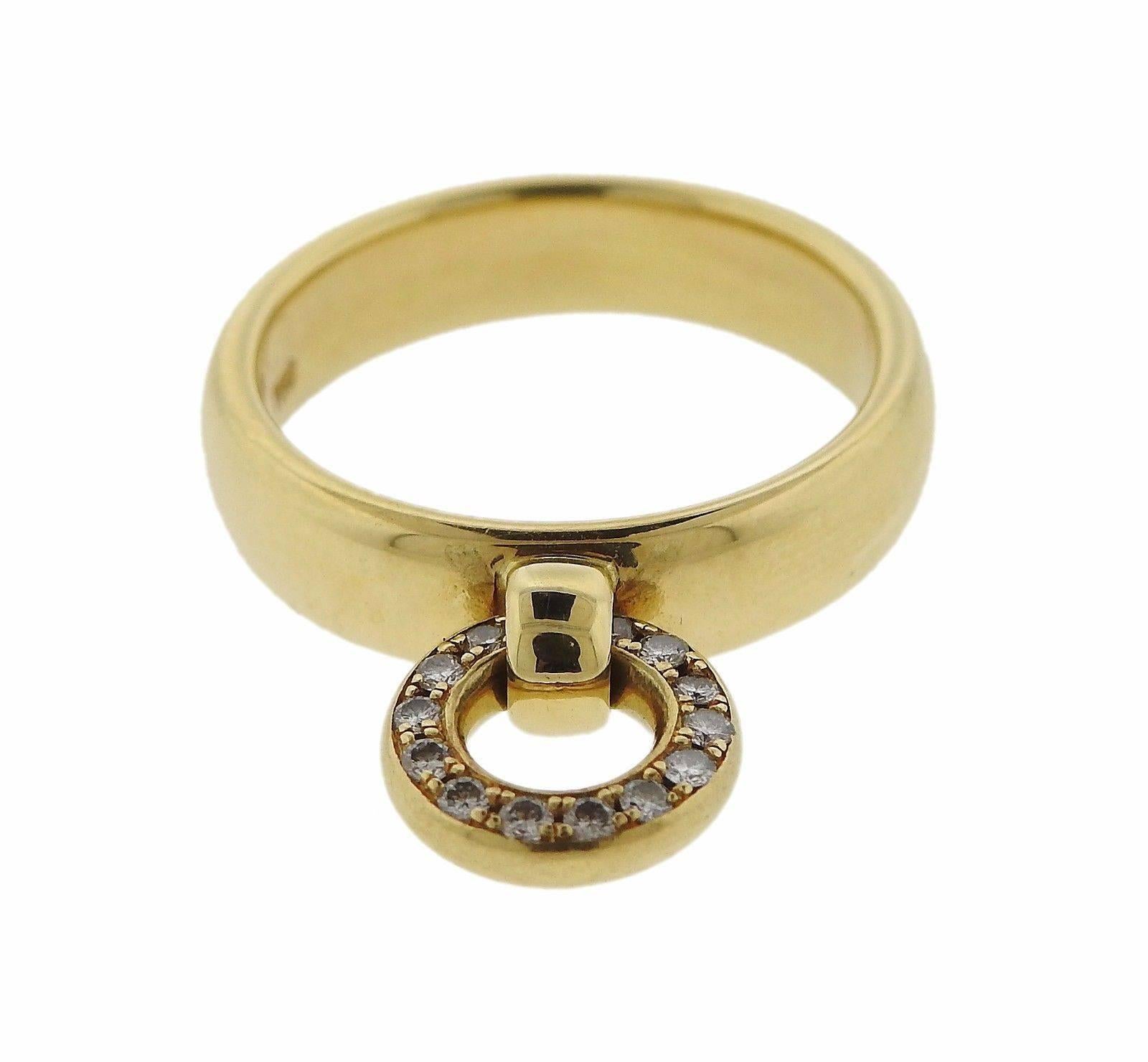 An 18k gold ring set with approximately 0.07ctw of G/VS diamonds.  The ring is a size 5 1/2, the band is 4.5mm wide and the charm is 9.2mm in diameter.  The weight of the piece is 7 grams. Marked: Tiffany & Co, 750, Israel.
