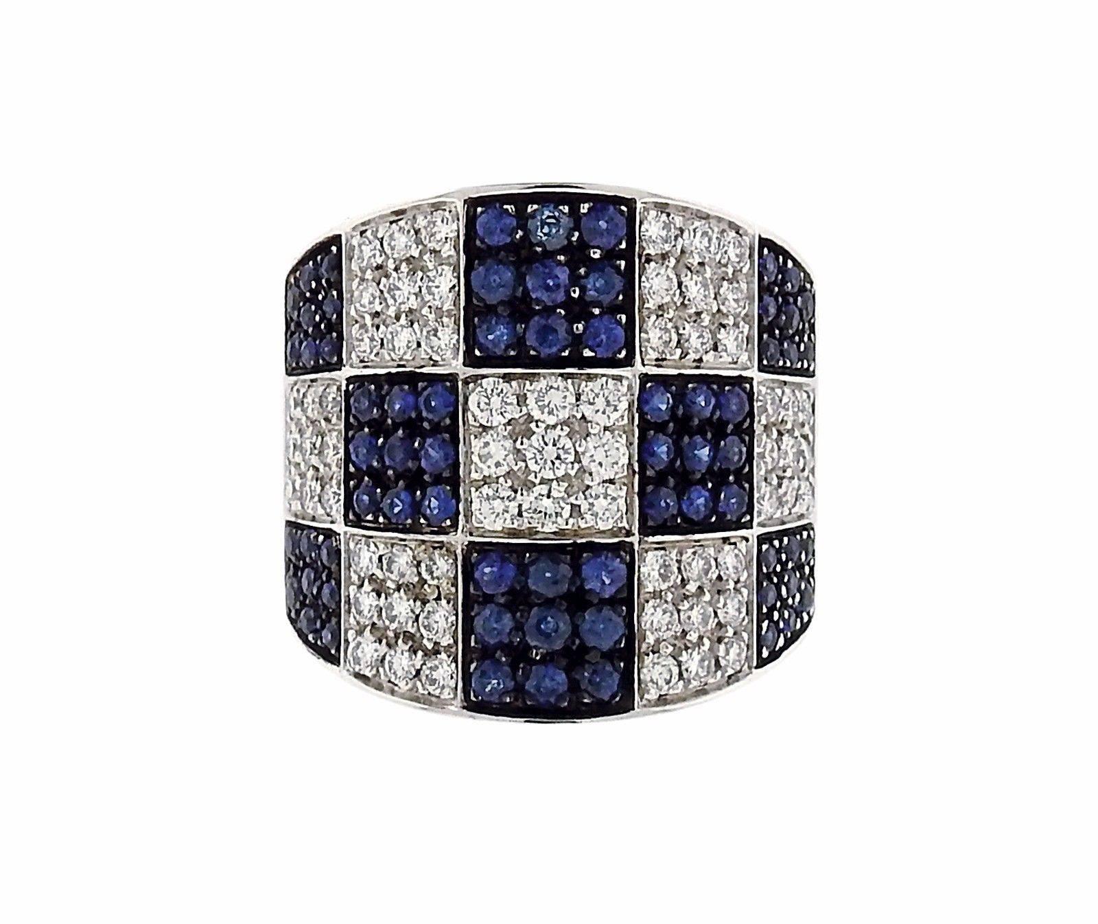An 18k white gold ring set with 0.87ctw of sapphires and approximately 0.96ctw of G/VS diamonds.  The ring is a size 7 and the ring top is 20mm wide. The weight of the piece is 15.4 grams. Marked: Enigma, 750, Italian Marks.  The current retail is