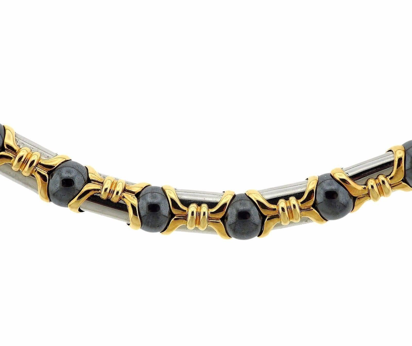 An 18k yellow gold and stainless steel necklace set with 8.4mm hematite stones.  The necklace is 16 1/2" long and weighs 105.5 grams.  Marked: Bvlgari, 750, M, 2337AL.