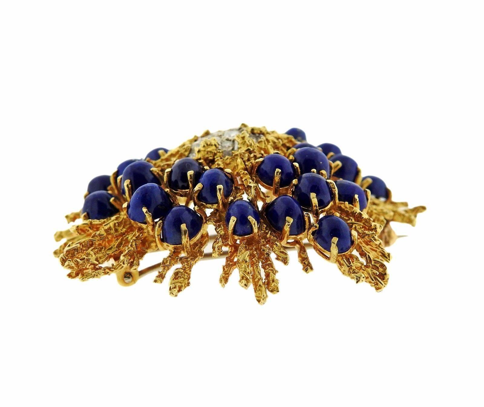An 18k yellow and white gold brooch set with lapis and approximately 0.80ctw of GH/VS diamonds.  The brooch measures 50mm x 45mm and weighs 33.8 grams.
