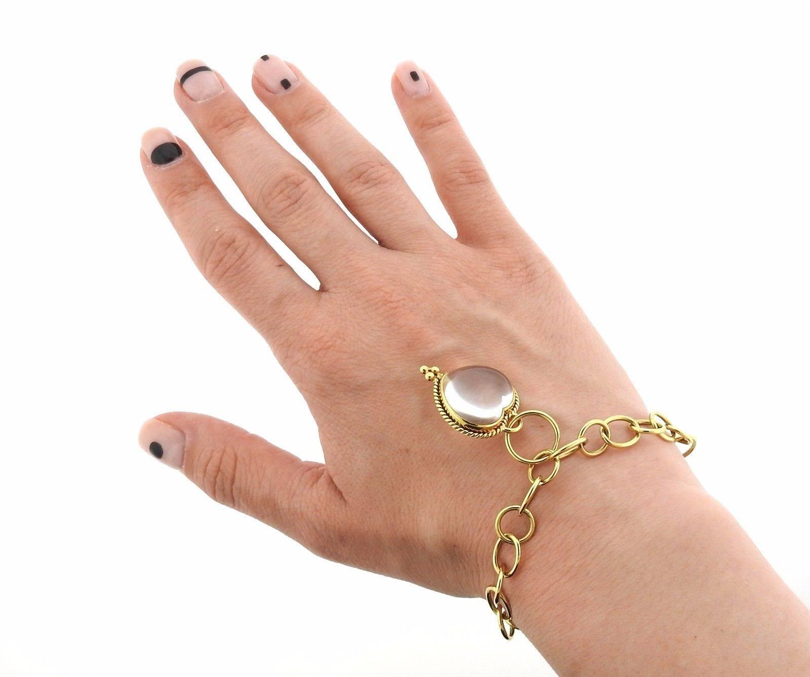 An 18k yellow gold charm bracelet by Temple St. Clair.  The bracelet is 7 1/8" long and 9mm wide.  The charm measures 29mm x 22mm. Marked: Temple Hallmark, 750.  The weight of the piece is 21.5 grams.