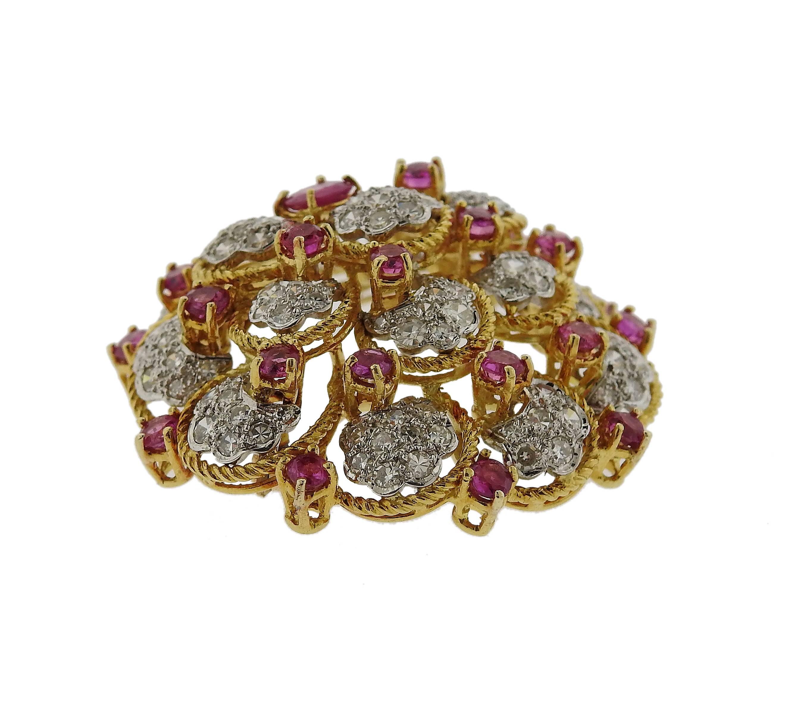 Circa 1960s 18k gold brooch pin, crafted by Orletto, decorated with rubies and approximately 2.60ctw in diamonds. Brooch is 38mm x 41mm and weighs 20.1 grams. Marked: Italy, Orletto, 18k.