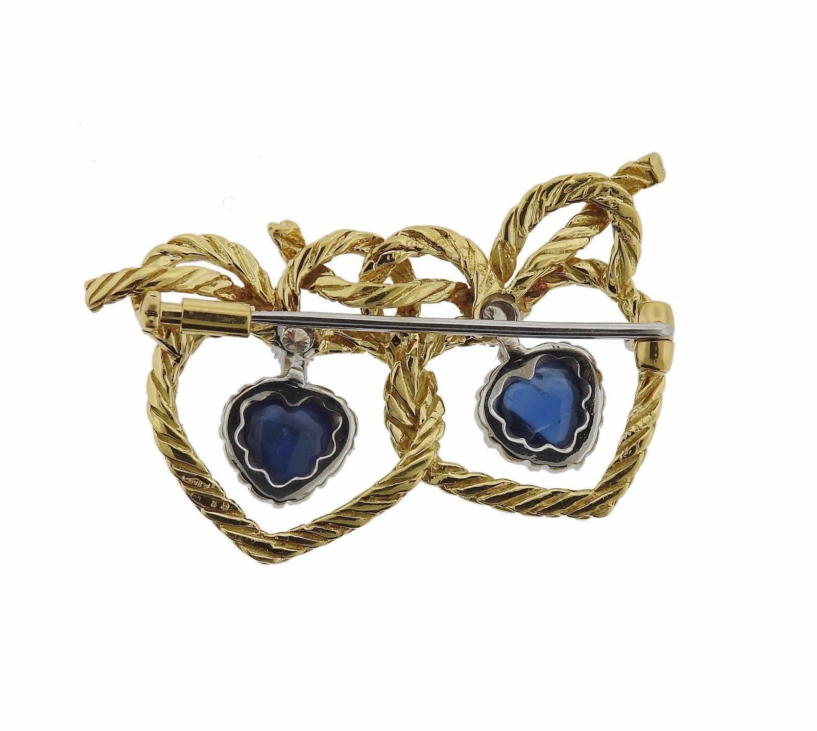 An 18k yellow gold brooch set with sapphires and approximately 0.11ctw of G/VS diamonds.  The brooch measures 36mm x 23mm and weighs 10.1 grams.  Marked: 750, 12 CG, 18k Buccellati.  Current retail is $5920.