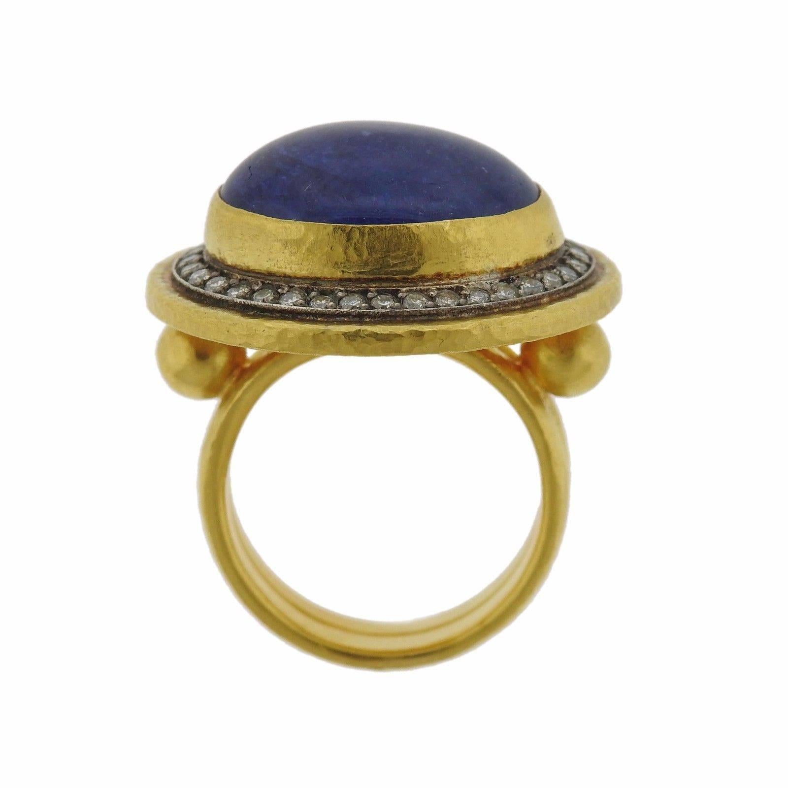 A 24k yellow gold ring set with a tanzanite cabochon (17.5mm x 13mm) and approximately 0.56ctw of H/VS diamonds.  The ring is a size 6 1/2, and the ring top measures 22mm x 25mm.  The weight of the piece Marked: Gurhan mark, RA03630, 0.990 H.