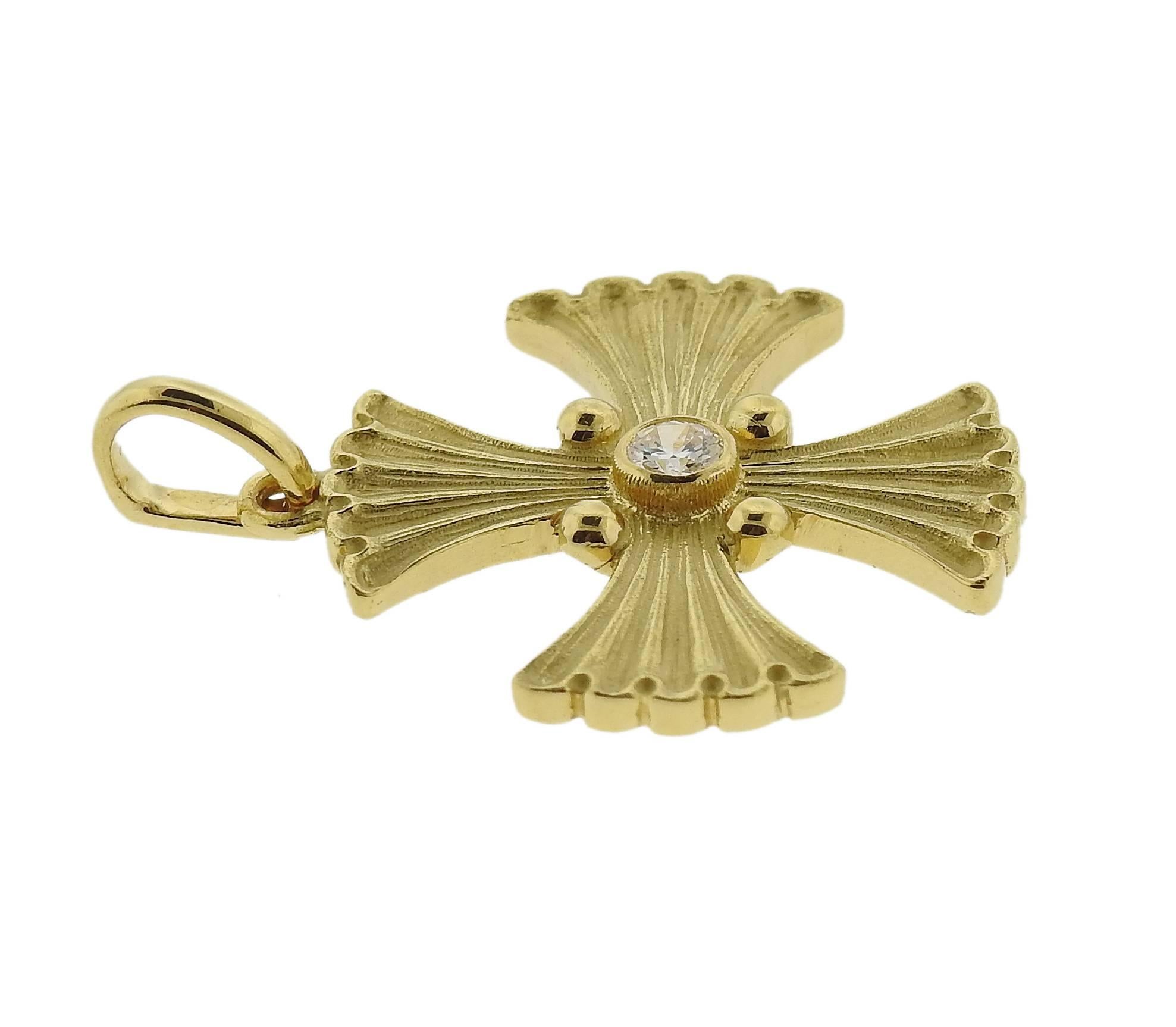 An 18k yellow gold cross pendant, crafted with approximately 0.10ct diamond in the center. Pendant is 27mm long with bale x 21mm wide   and weighs 5.5 grams. Marked: Buccellati, 18k Italy 