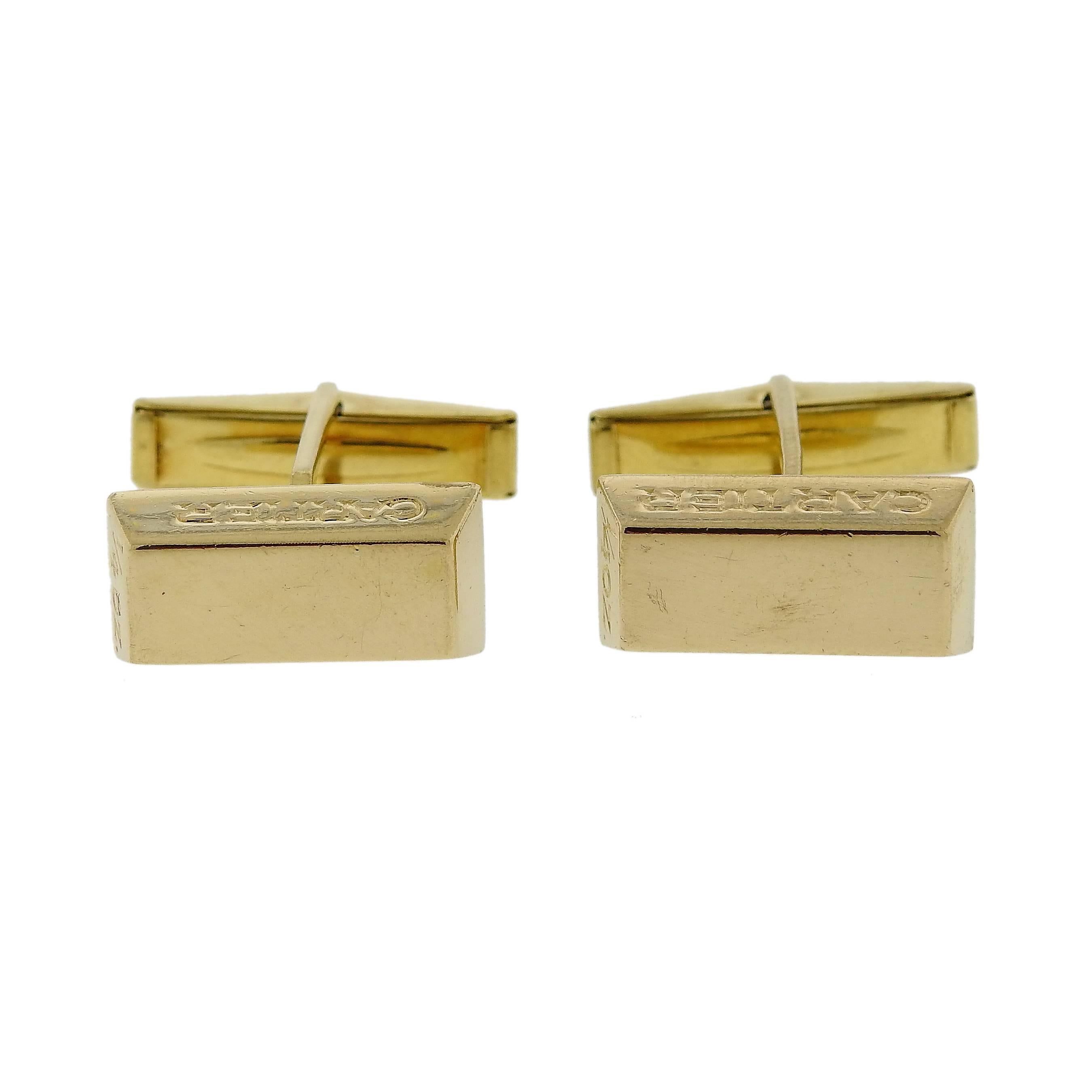 Pair of 18k yellow gold bar cufflinks, crafted by Cartier, containing 1/4oz each.  Each cufflink top is 17mm x 8.7mm and weigh 20.7 grams. Marked: Cartier, 1/4oz, 18k