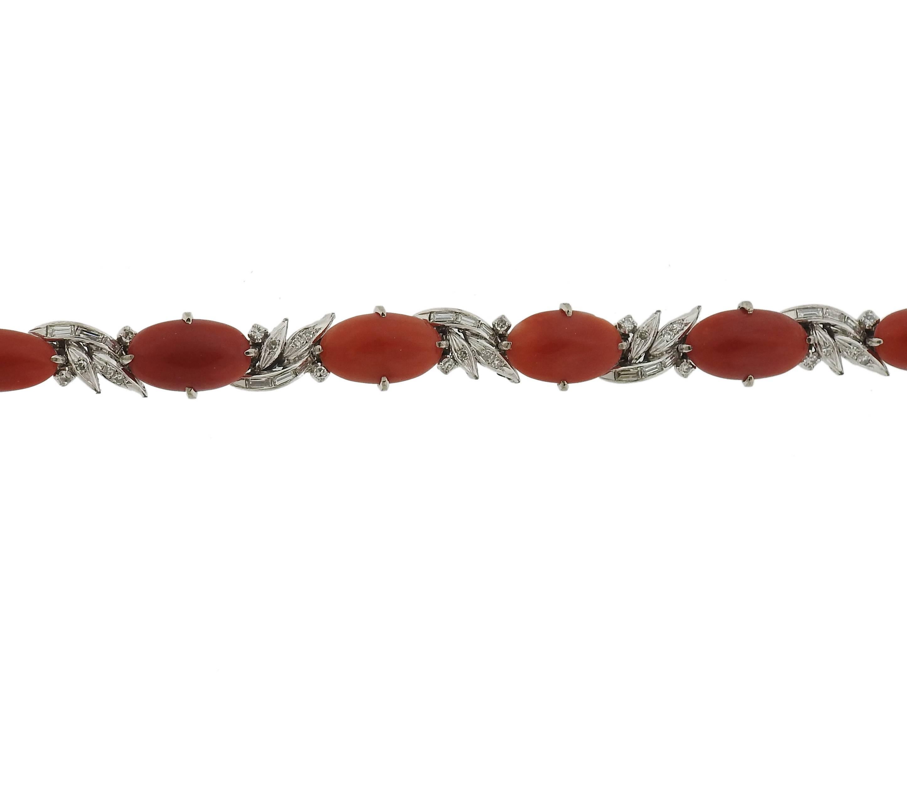 14k white gold bracelet, set with coral stones, surrounded with approximately 0.80ctw in diamonds. Bracelet is 6 1/2