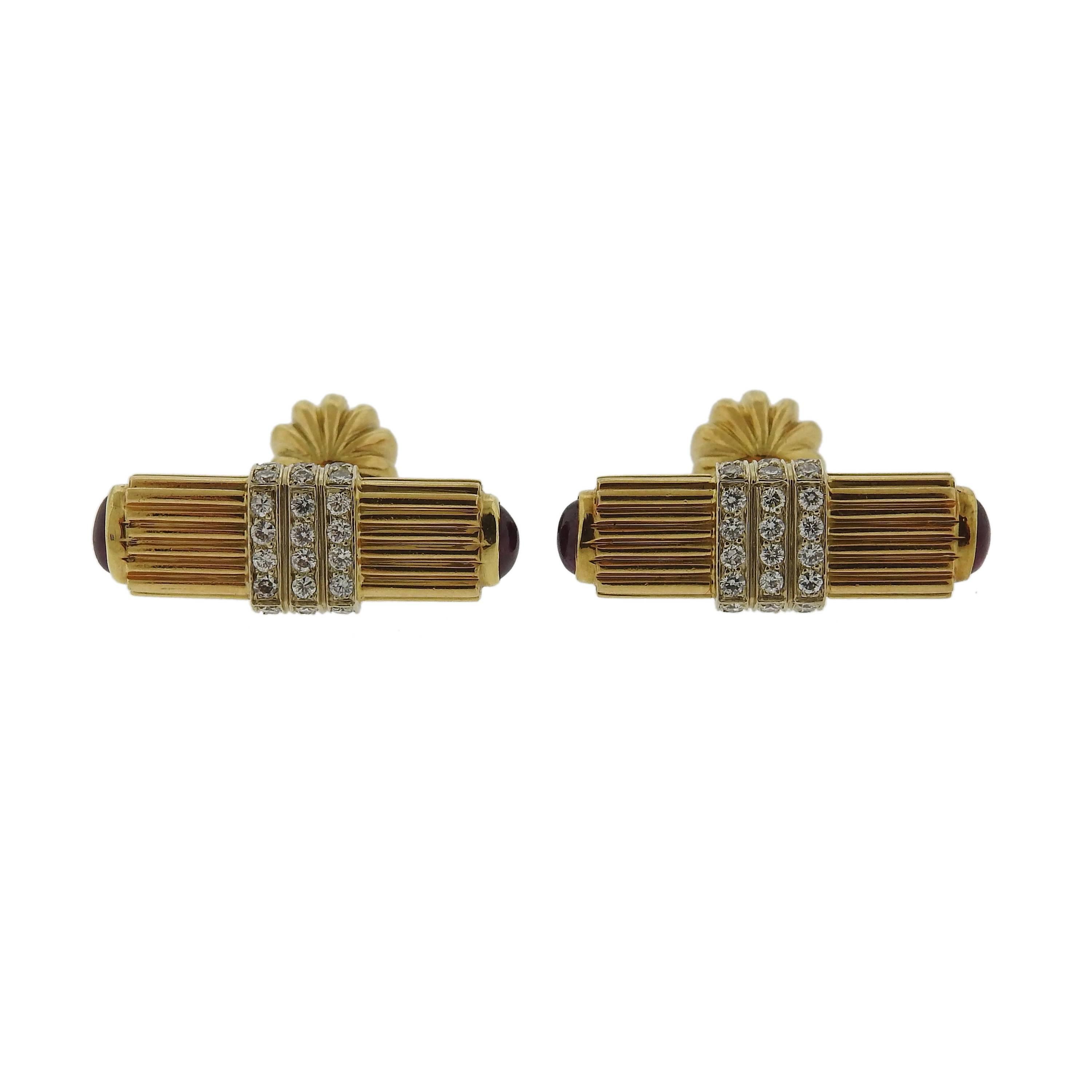 A pair of 18k gold cufflinks. Set with 0.72cw of H/SI diamonds and ruby cabochons. Cufflink tops measure 29mm X 11mm. Marked: CY 18k. Weight is 18.4 grams. 