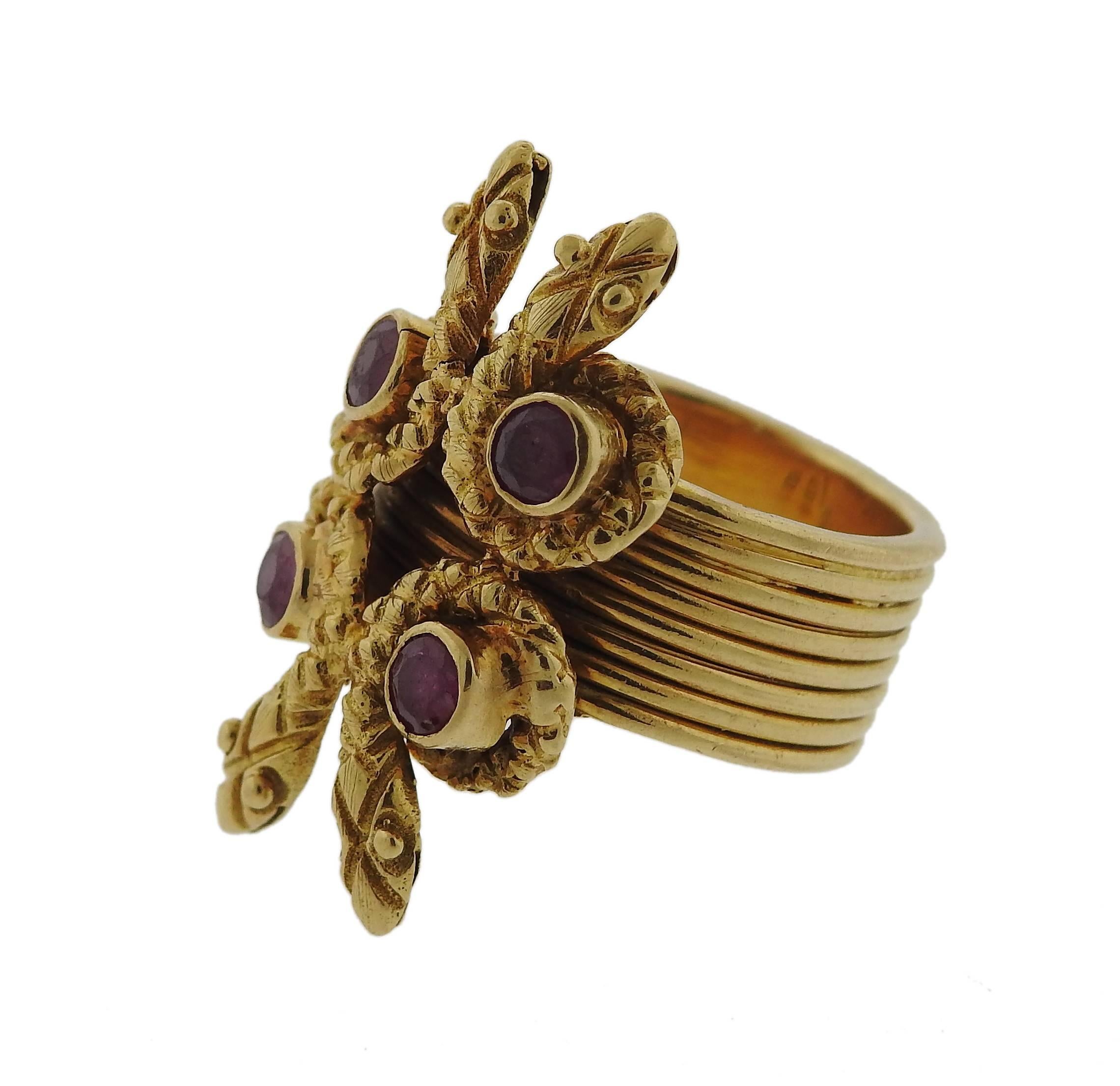 An 18k gold snake ring crafted by Zolotas featuring rubies. Ring is a size 5, ring top is 26mm x 14mm. Marked k18, Greece, Maker's mark . Weight is 11.7 grams.