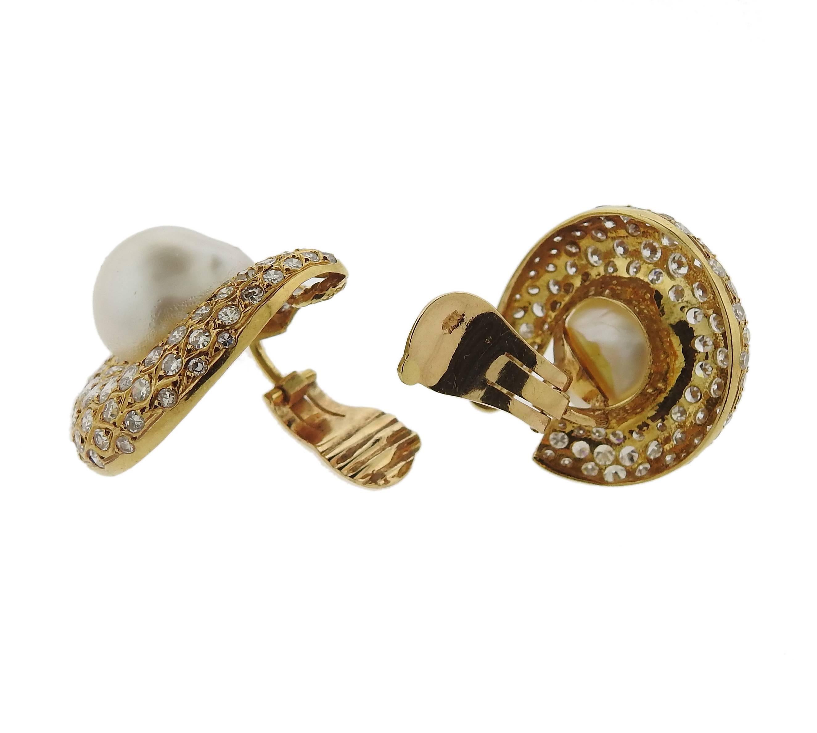 A lovely pair of 18k gold pearl earrings. Set with approximately 6 carats of GH/VS diamonds and a 14.5mm south sea pearl. Earrings measure 30mm X 26mm. Weight is 27.9 grams.