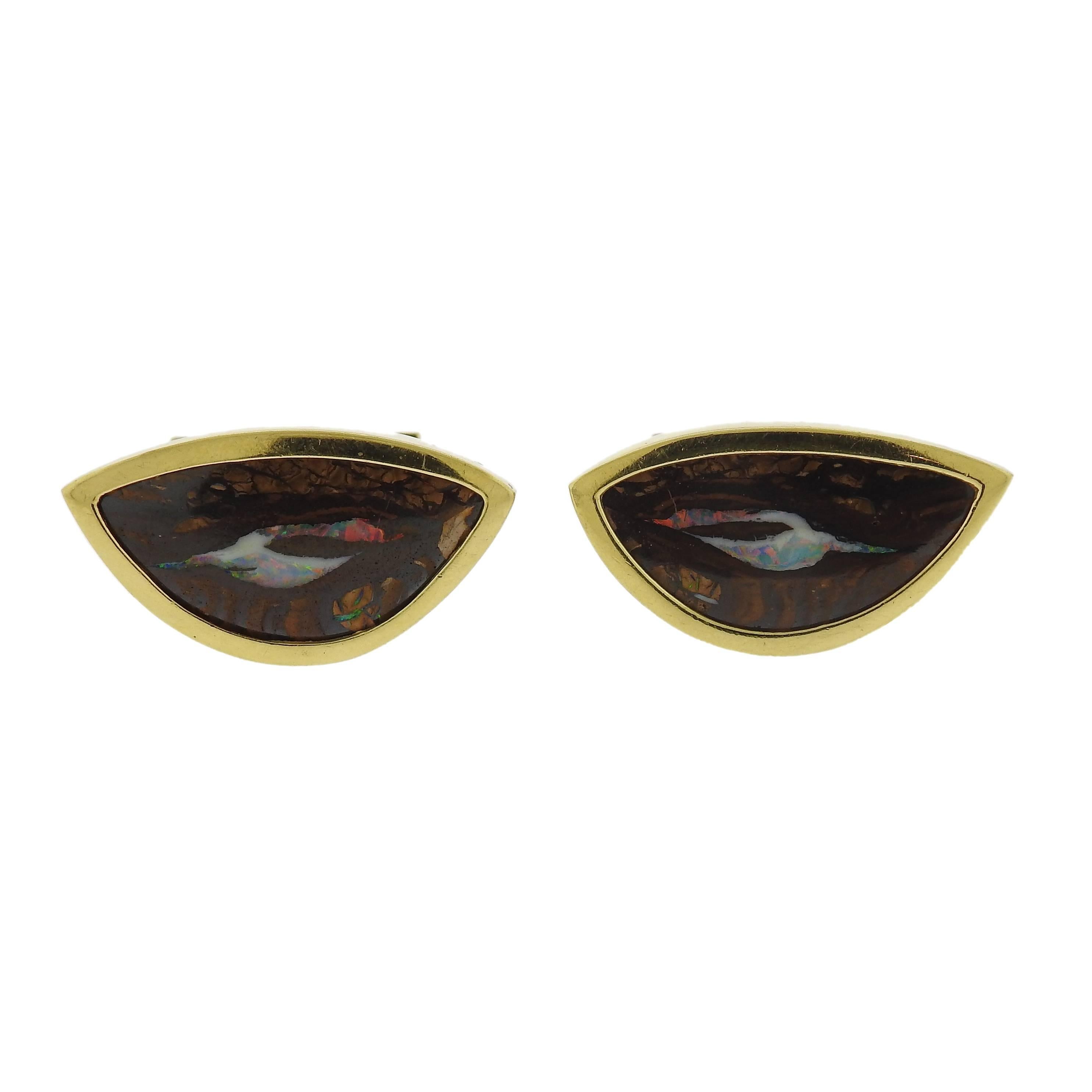 Pair of 18k yellow gold cufflinks, featuring boulder opal stones in the center.   cufflink top measures 31mm x 16mm at widest point. Marked 18k. Weight - 33.5 grams 
