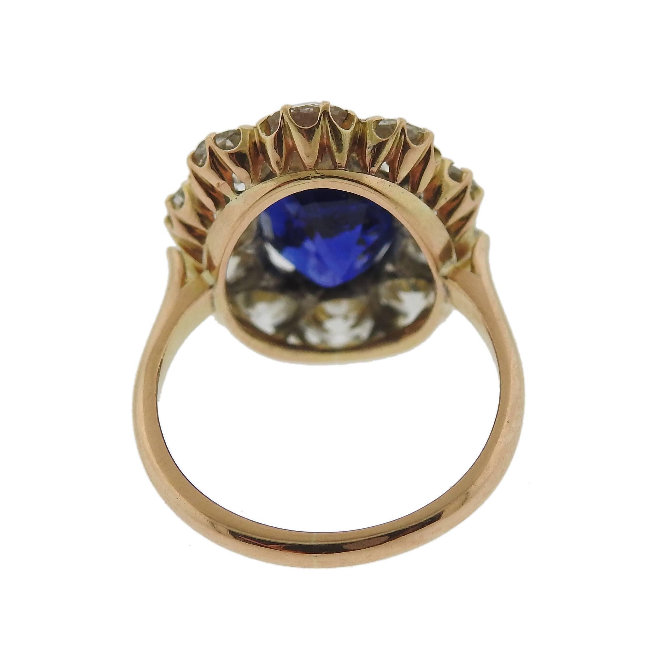 18k gold ring, featuring an impressive 4.41ct natural Burma oval sapphire, certified by AGL, sapphire measures 10.97mm x 7.79mm x 6.05mm , with no gemological evidence of heat;  surrounded with approximately 3 carats in old mine cut diamonds. Ring
