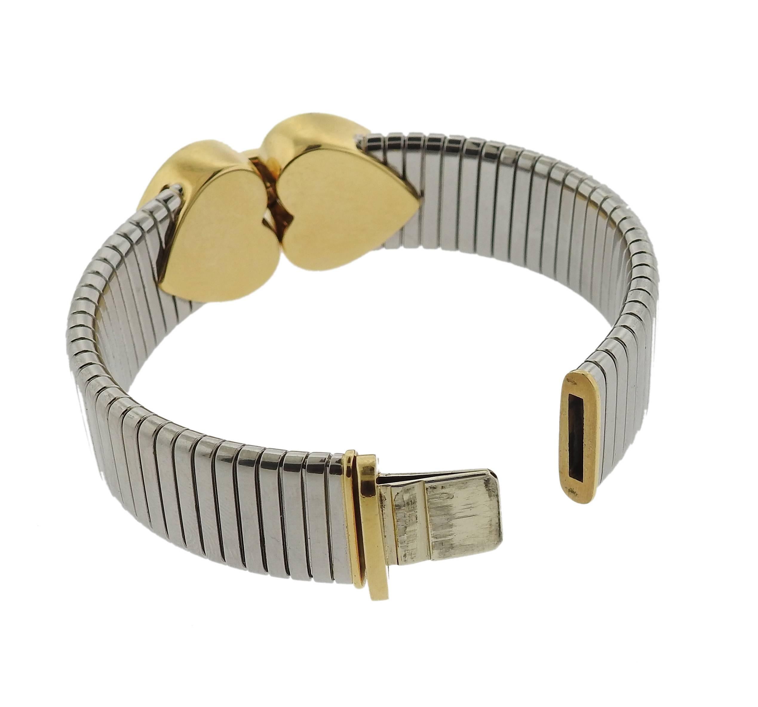 18k gold and stainless steel bracelet, crafted by Bulgari for signature Tubogas collection. Bracelet is 6 3/4" long, widest point is 20mm. Marked: Bvlgari, 750, 2337AL, ORetActer. Weight of the piece - 67.4 grams 