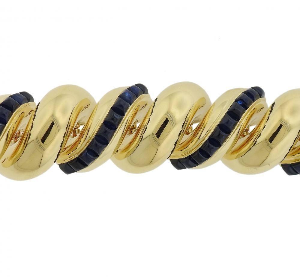 An 18k yellow gold bracelet set with sugarloaf cut sapphires.  The bracelet is 6 3/4