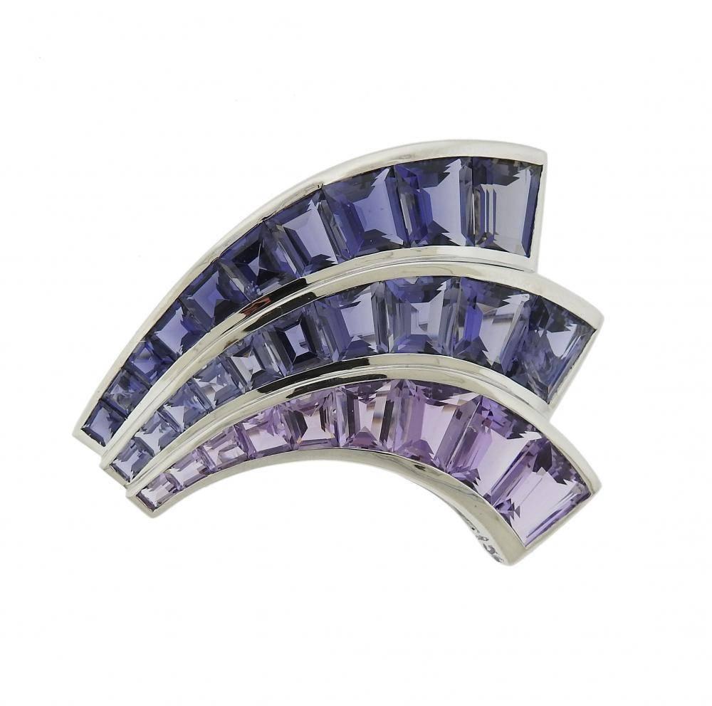 A pair of 18k white gold brooches set with iolite and amethyst.  Each brooch measures 56mm x 44mm.  The pair weighs 55 grams.  Marked: Shell signature mark, 750, 22616. Current retail for each brooch is $17,600.