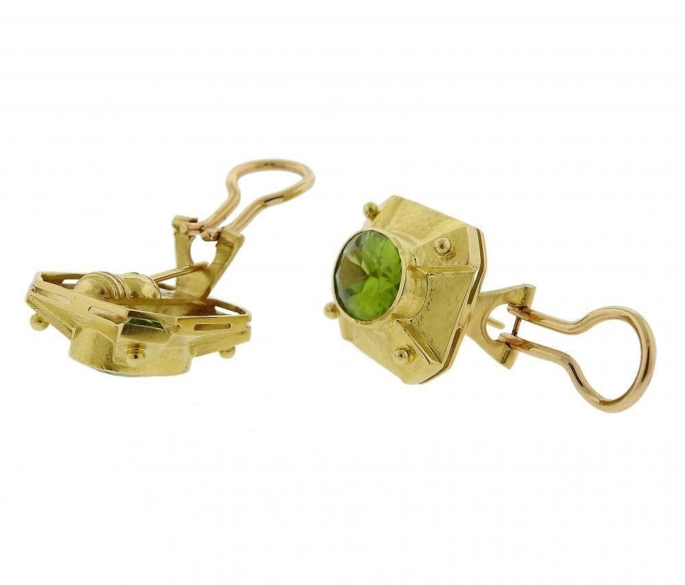 A pair of 18k yellow gold earrings set with peridot (14mm x 10mm).  The earrings measure 22mm x 20mm and weigh 18 grams. Marked with the Maker's mark and 18k.