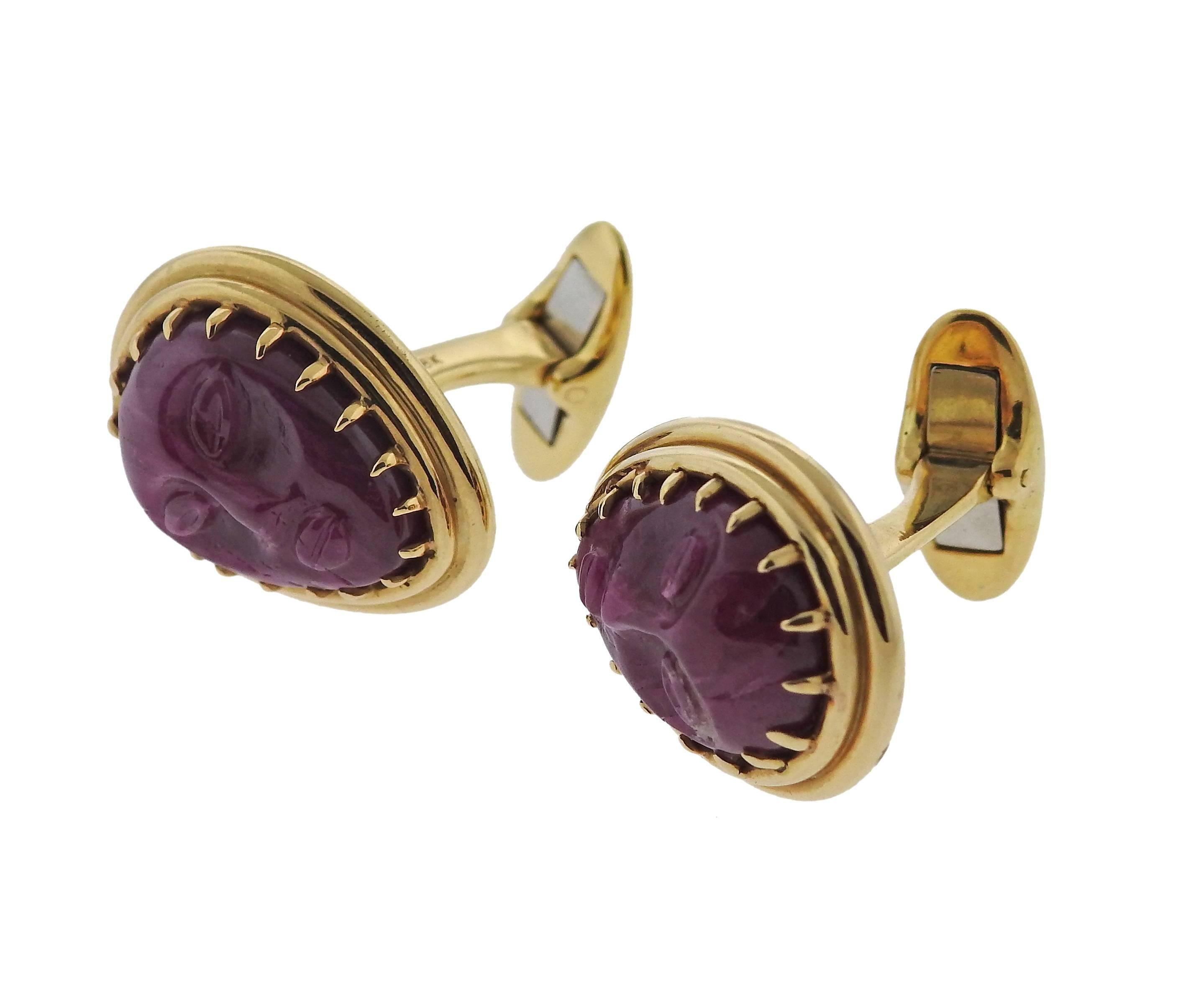 Pair of unusual 18k yellow gold large cufflinks, decorated with carved rubies, depicting faces. Each top measures 23mm x 18mm. Marked 18k. Weight - 29.4 grams 