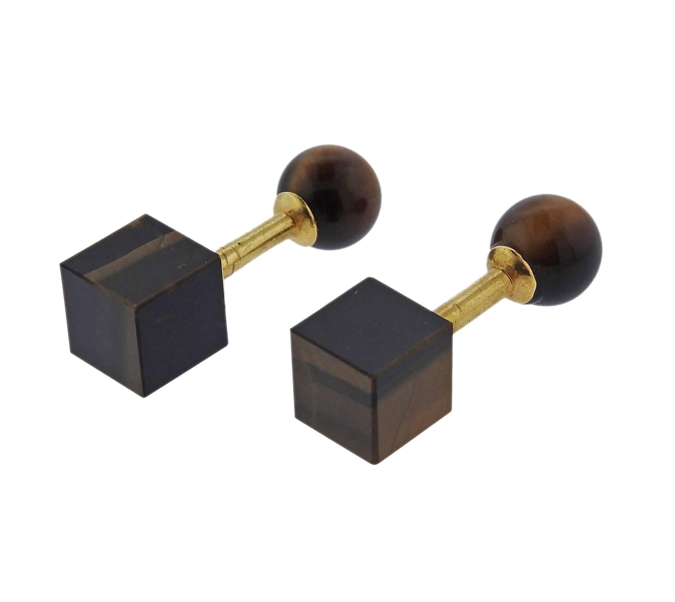 Pair of 18k yellow gold geometric cufflinks, crafted by Tiffany & Co, featuring tiger's eye ball and a cube top. Ball is 9mm in diameter, cube - 8.9mm x 8.9mm . Marked: Tiffany 18k. Weight - 8.6 grams 
