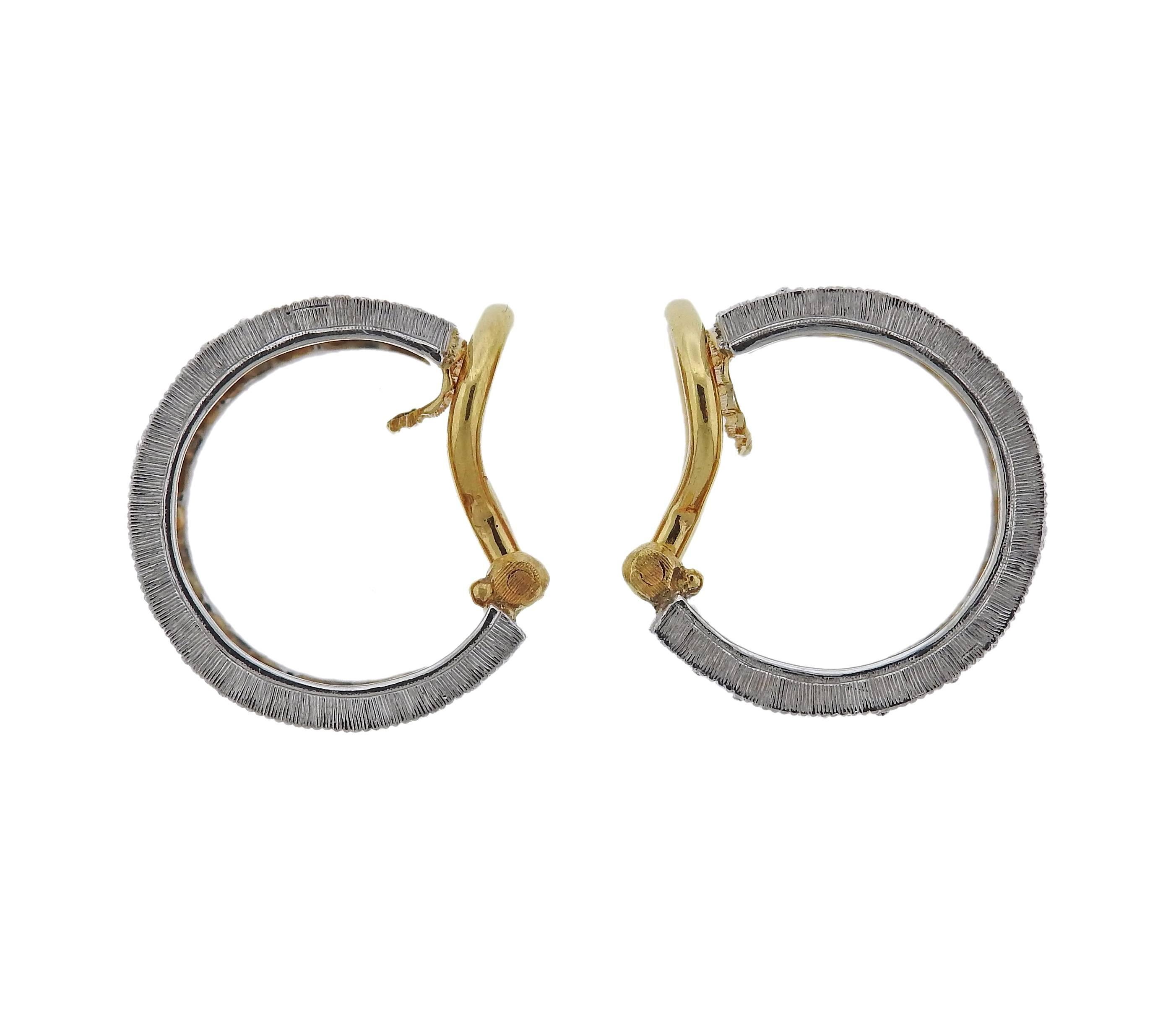 A pair of 18k gold hoop earrings crafted by Buccellati. Earrings feature approximately 0.85ctw of H/VS diamonds. Earrings measure 16mm in diameter and 9.5mm wide. Marked Q3061, 18k, Buccellati , Italy . Weight is 10.3 grams. Retail for $23200 come