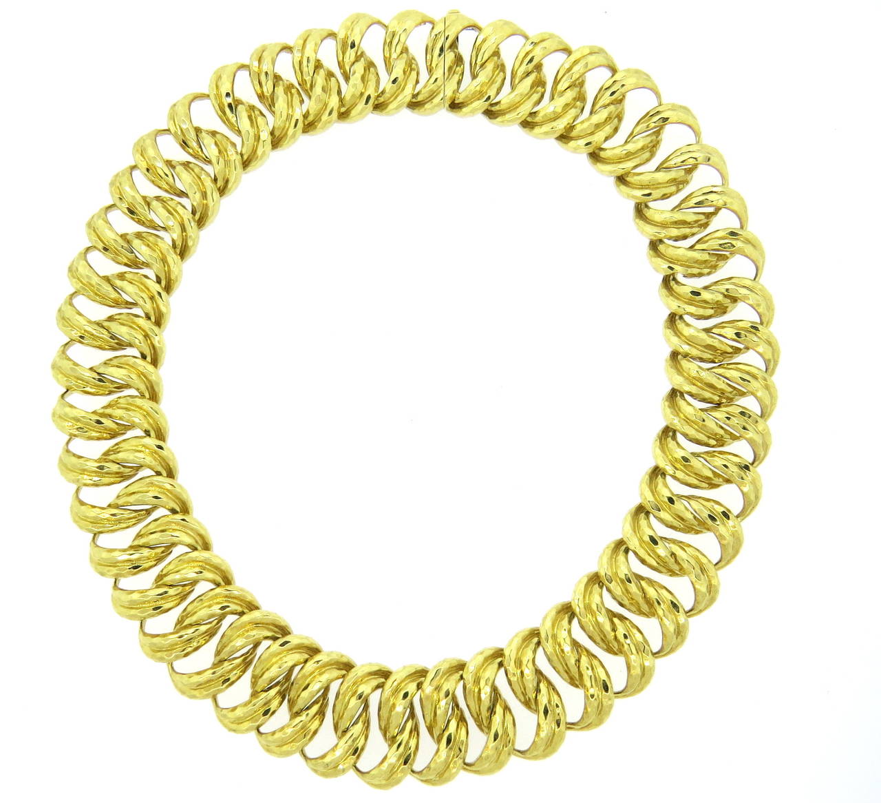 An 18k yellow gold necklace with a hammered finish.  Crafted by Henry Dunay, the necklace is 17