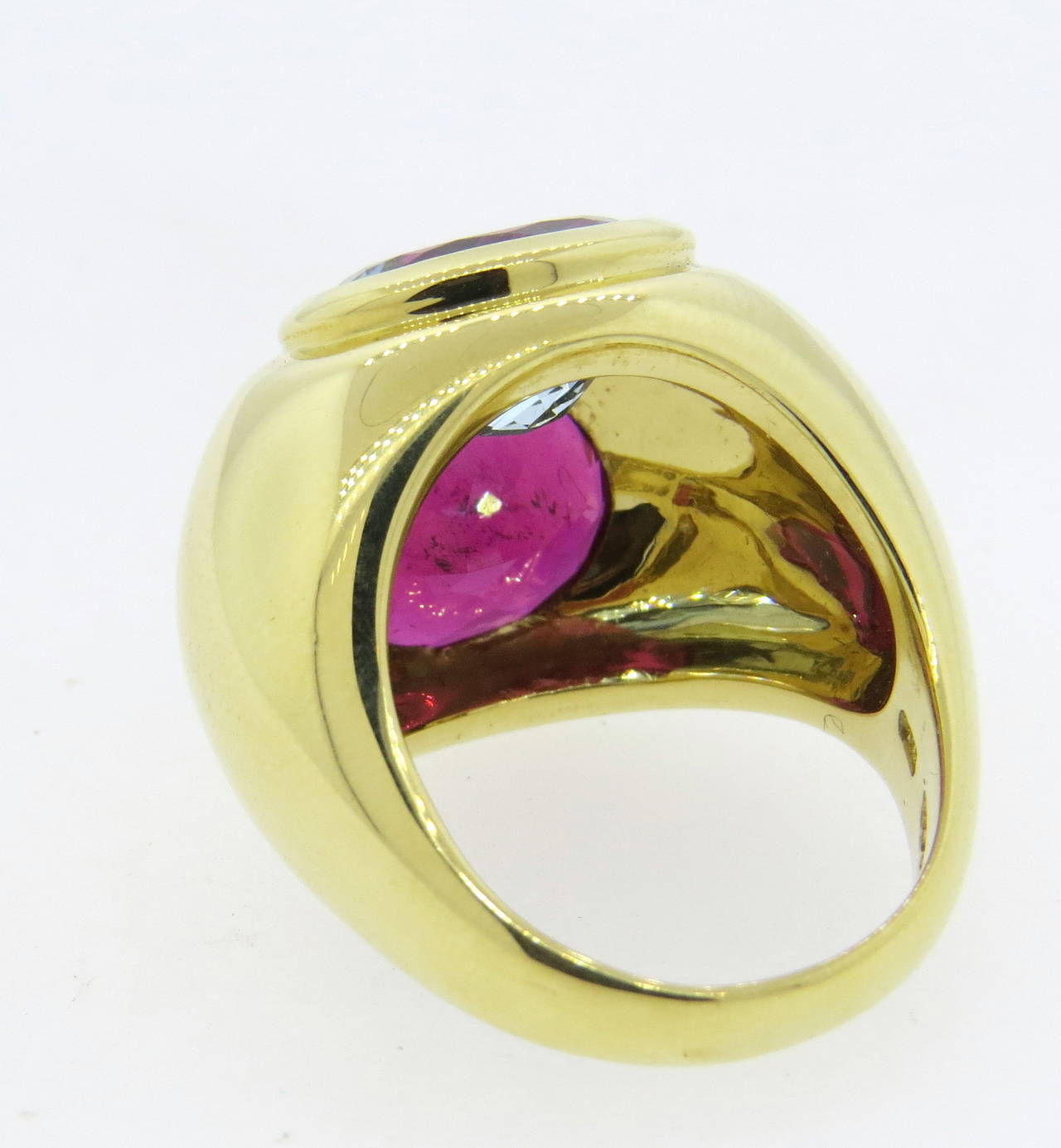 An 18k yellow gold dome ring set with an aquamarine measuring 9.1mm x 11.3mm and a rubellite tourmaline measuring 9.1mm x 11.3mm. The top of the ring measures 21mm in width and sits 9mm from finger. Crafted by Paloma Picasso for Tiffany & Co., the