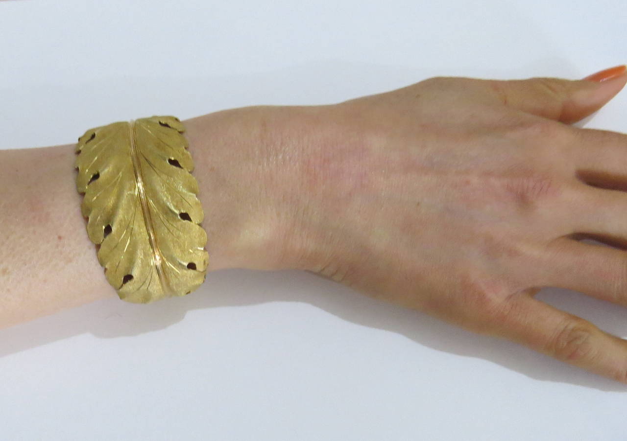 An 18k yellow gold cuff bracelet in a leaf motif.  Crafted by Mario Buccellati, the bracelet measures 37mm at the widest point and fits up to a 6.5