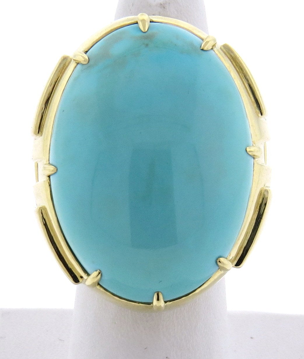 An 18k yellow gold cocktail ring set with a Persian turquoise 33mm x 23mm.  Crafted by David Webb, the ring is a size 6.75.  The top of the ring measures 38mm x 31mm and sits 19mm from the finger.  The weight of the ring is 39 grams.  Marked: Webb