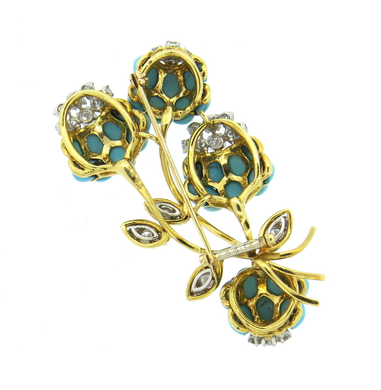 An impressive 18k yellow gold brooch set with approximately 2.20ctw in G/VS diamonds and Persian Turquoise.  The brooch measures 63mm x 38mm and weighs 33.3 grams.  Marked: 2038