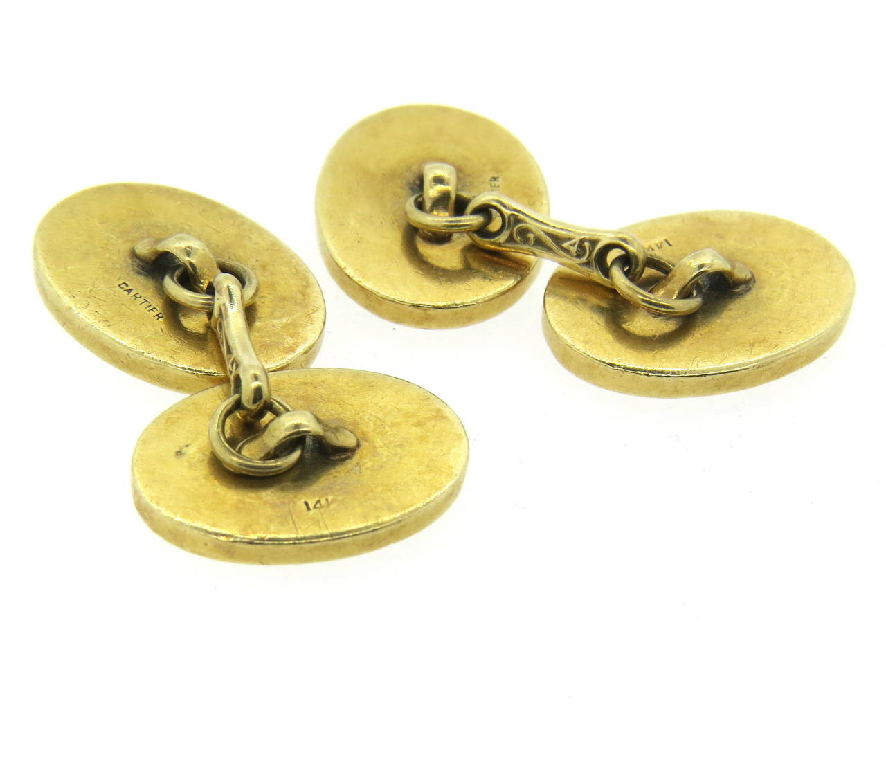 Mid Century 14k gold carver oval top cufflinks, measuring 18mm x 13mm. Marked 14k and Cartier. weight - 23.7 grams