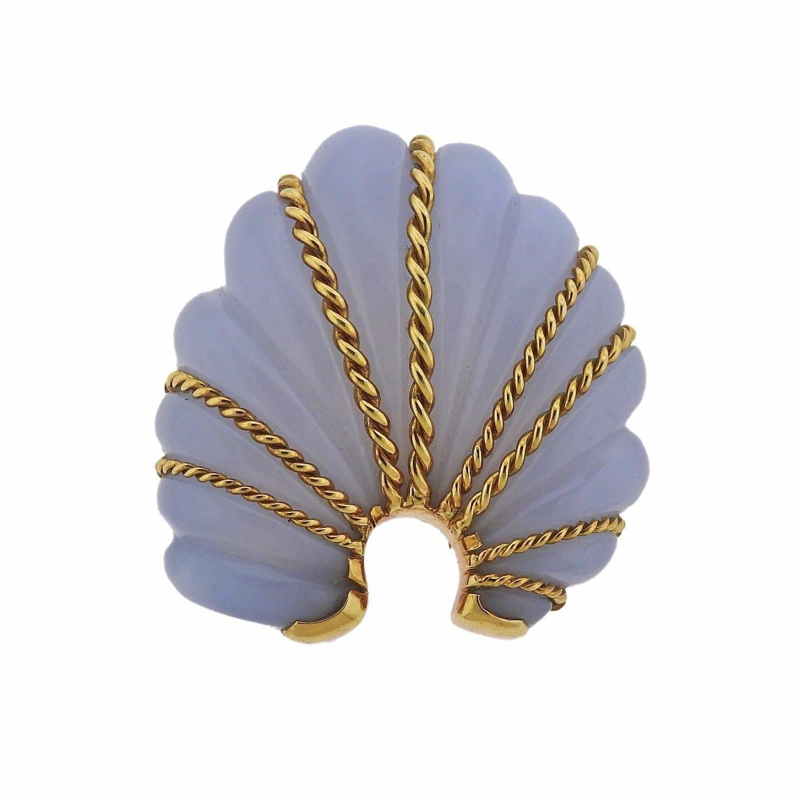 An 18k yellow gold brooch set with chalcedony.  The brooch is 53mm x 50mm and weighs 55.3 grams.  Marked: Shell signature mark, 11348, 750, Seaman Schepps.