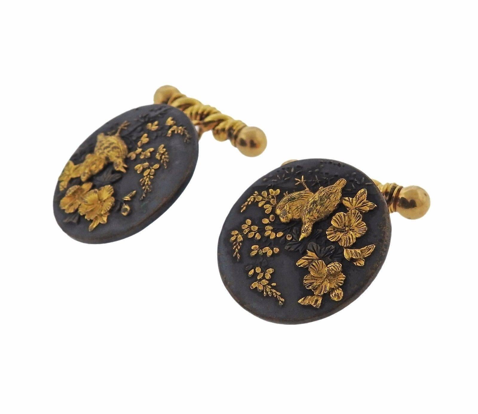A pair of 14k yellow gold and shakudo metal cufflinks.  The cufflinks measure 27mm in diameter and weigh 30.7 grams.