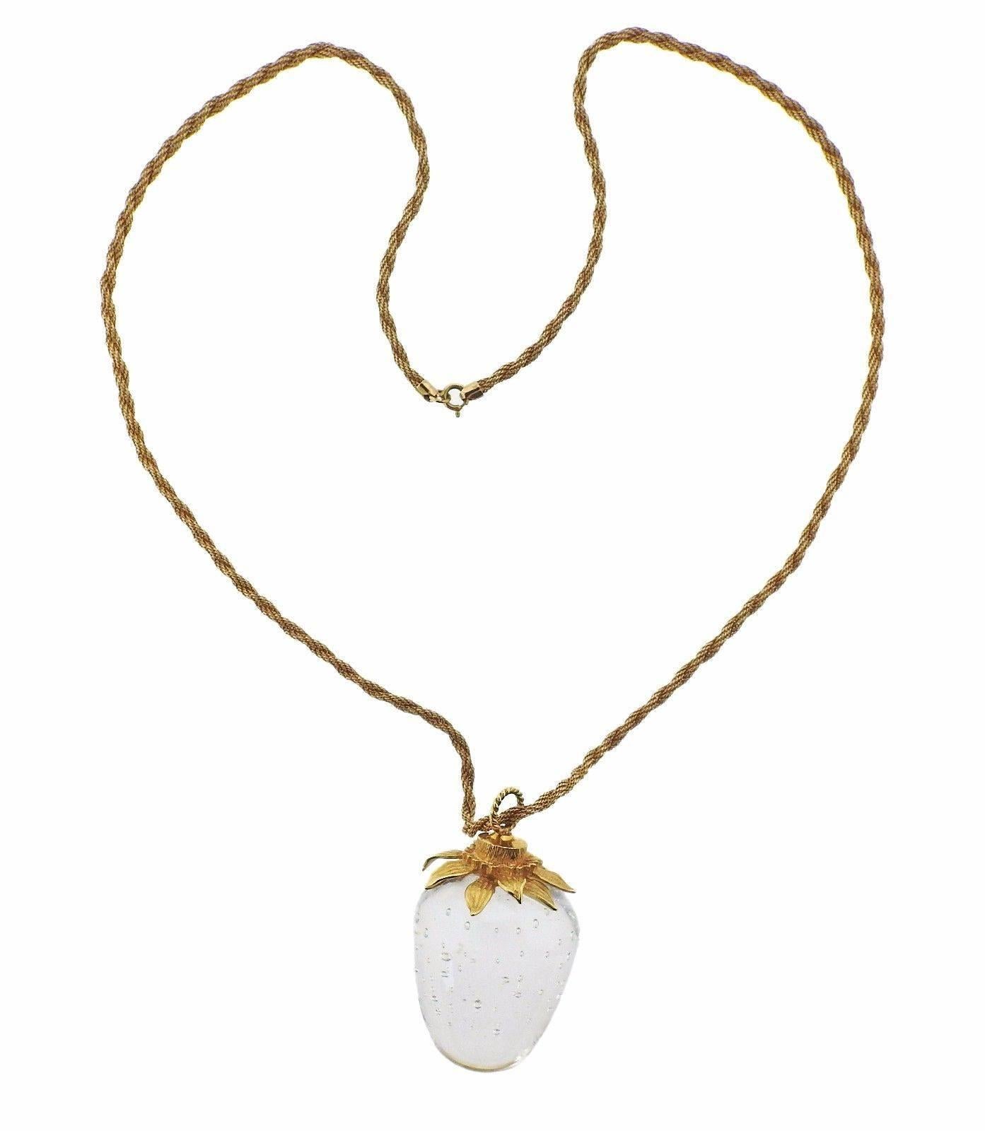 An 18k yellow gold necklace with a glass strawberry pendant by Steuben.  The necklace is 25" long, pendant is 49mm x 30mm.  Marked: S, 18k.  The weight of the necklace is 74.8 grams.