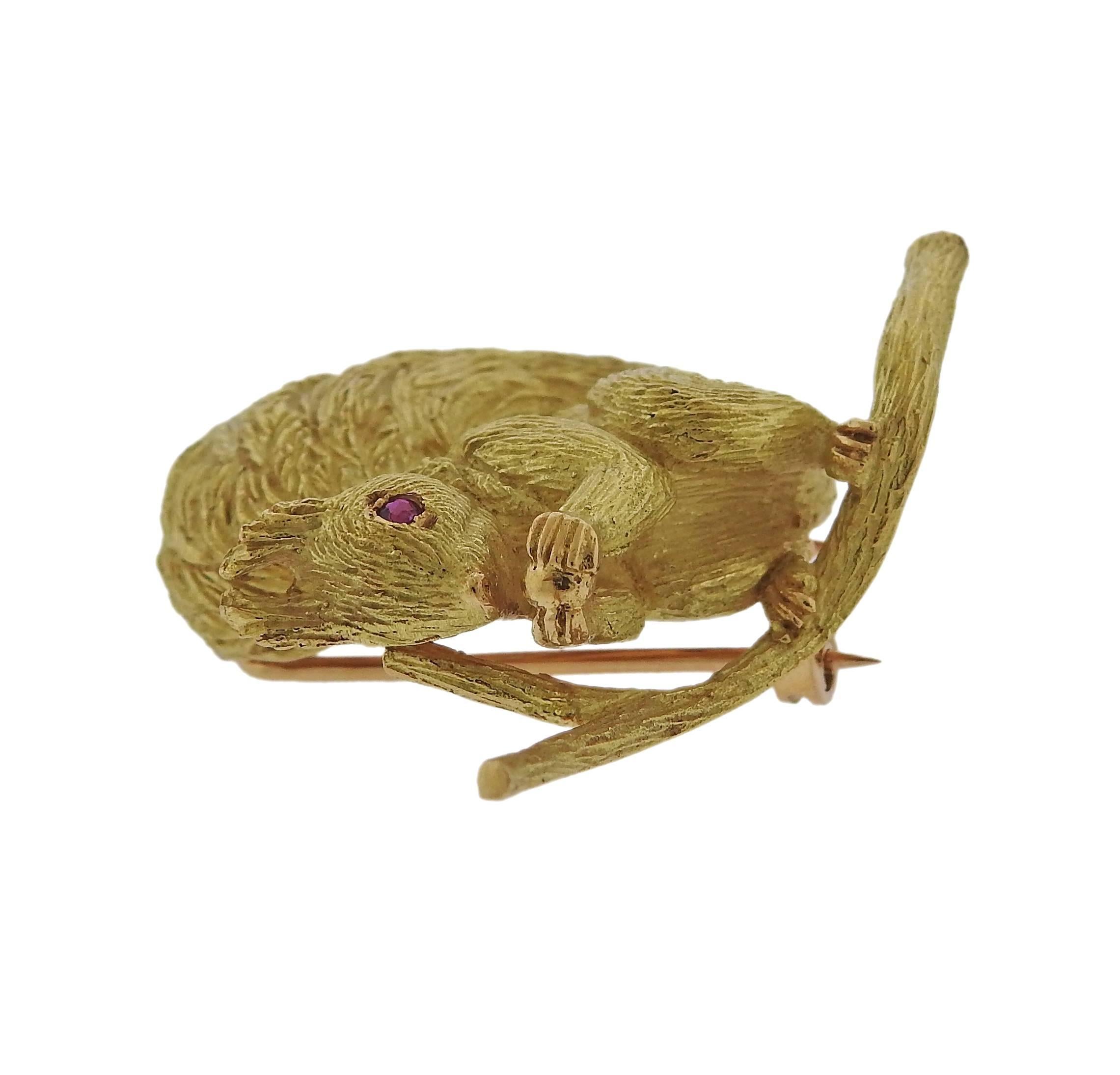 An 18k gold squirrel brooch pin featuring rubies crafted by Hermes. Brooch measures 38mm X 40mm. Marked Hermes Paris French Assay Mark. Weight is 16.4 grams. 