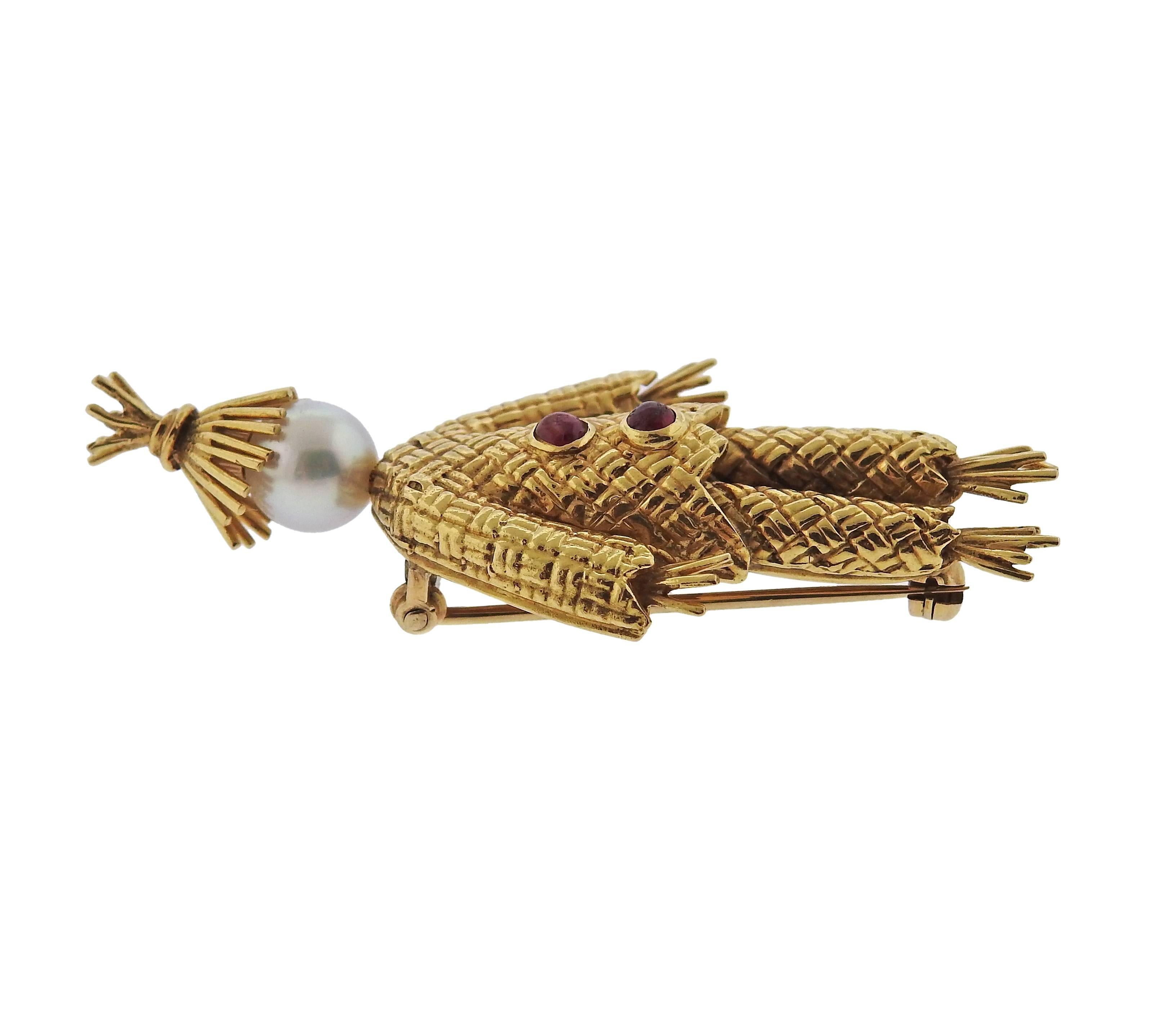 An 18k gold pearl ruby scarecrow brooch pin crafted by Van Cleef & Arpels. Brooch measures 53mm X 24mm. Marked VCA NY 18k. Weight is 10.8 grams. 
