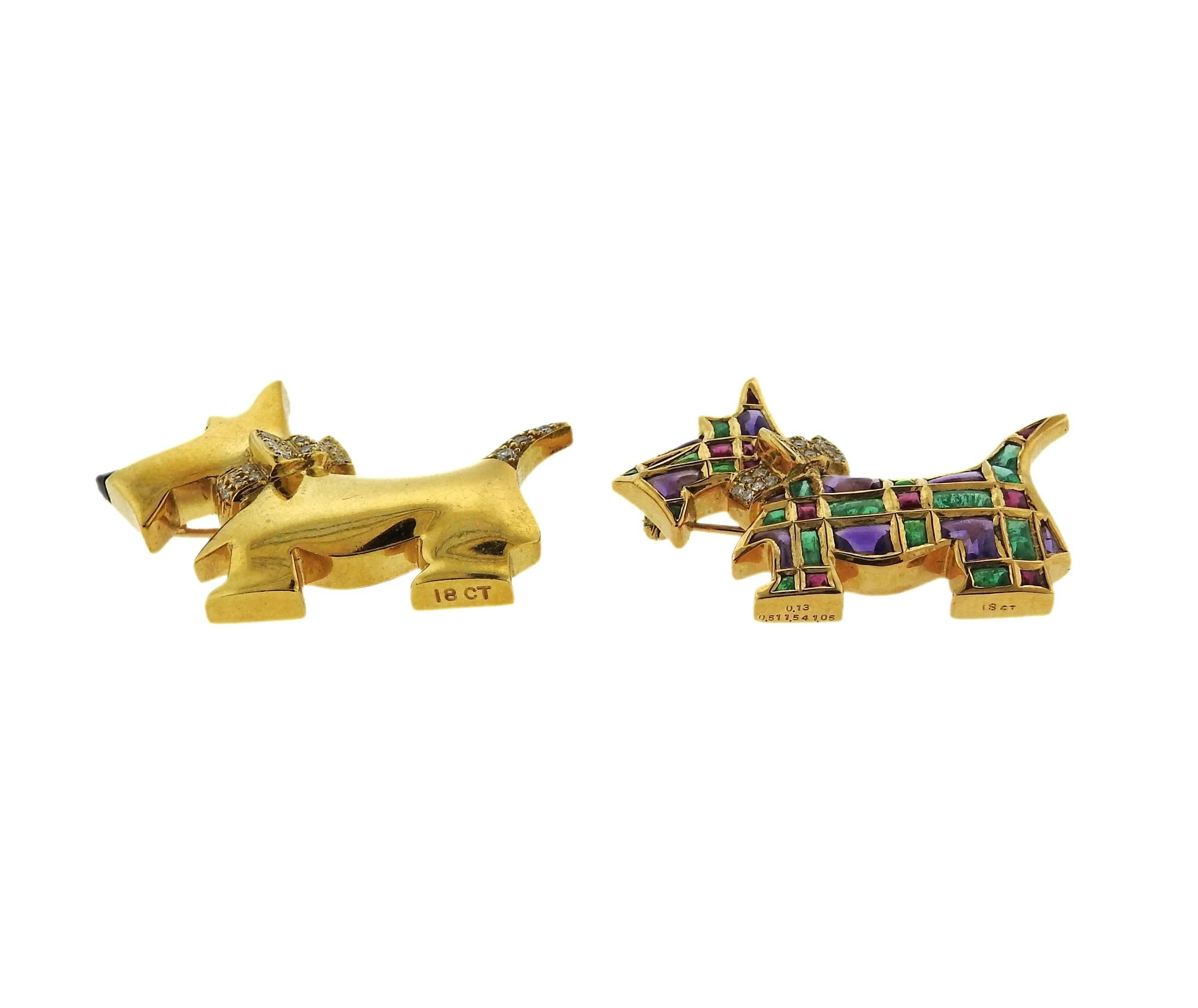 A pair of 2 westie dog brooches crafted from 18k gold featuring emeralds, rubies, and amethyst. Brooch with multi color stones measures 40mm x 29mm at widest point, other brooch measures 41mm X 31mm. Marked 18CT; 0.13; 0.51; 1.54; 1.05. Weight is