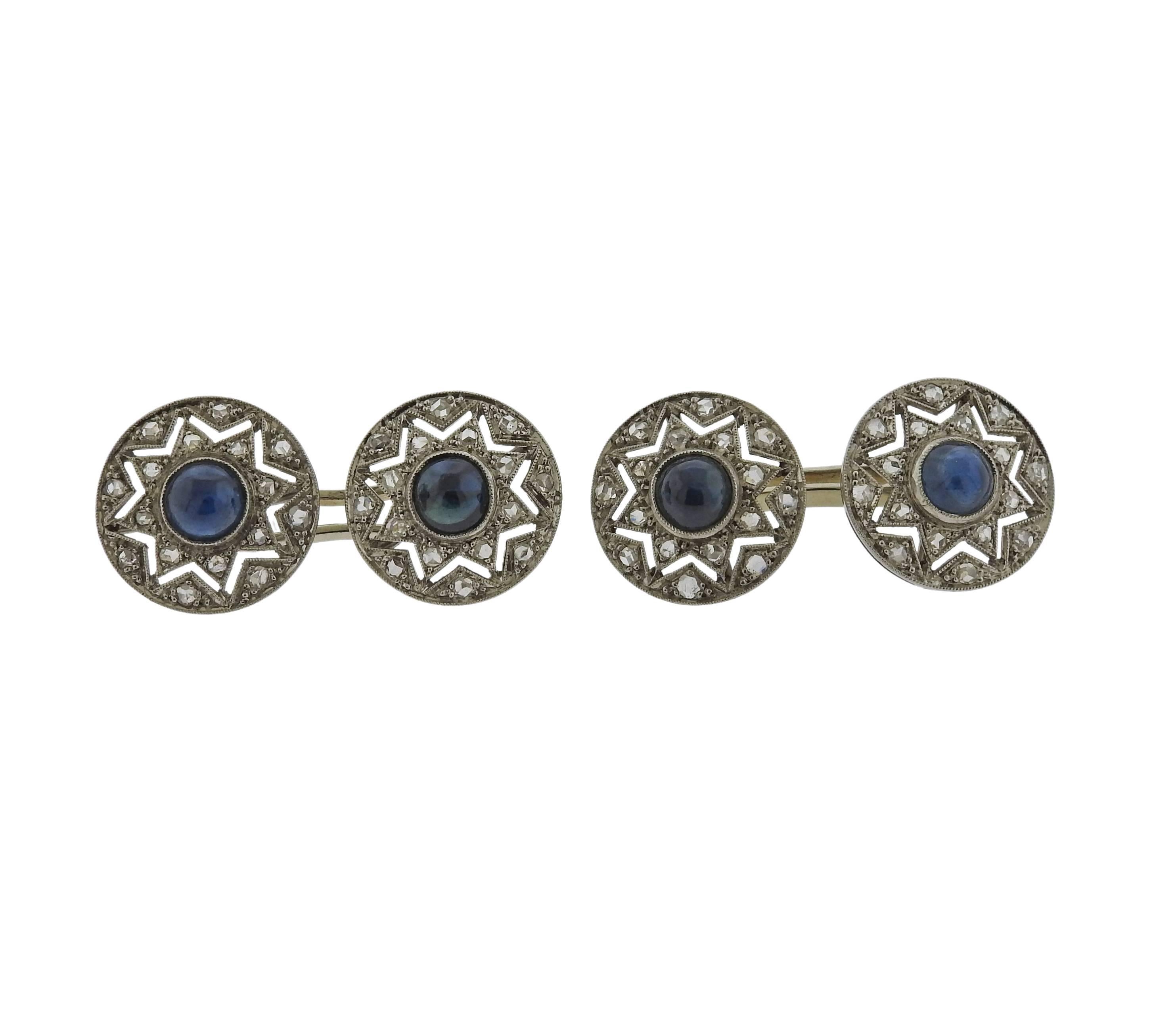 A pair of platinum art deco cufflinks featuring rose cut diamonds and sapphire cabochons. Cufflink tops measure 14.4mm in diameter. Weight is 10.7 grams. 