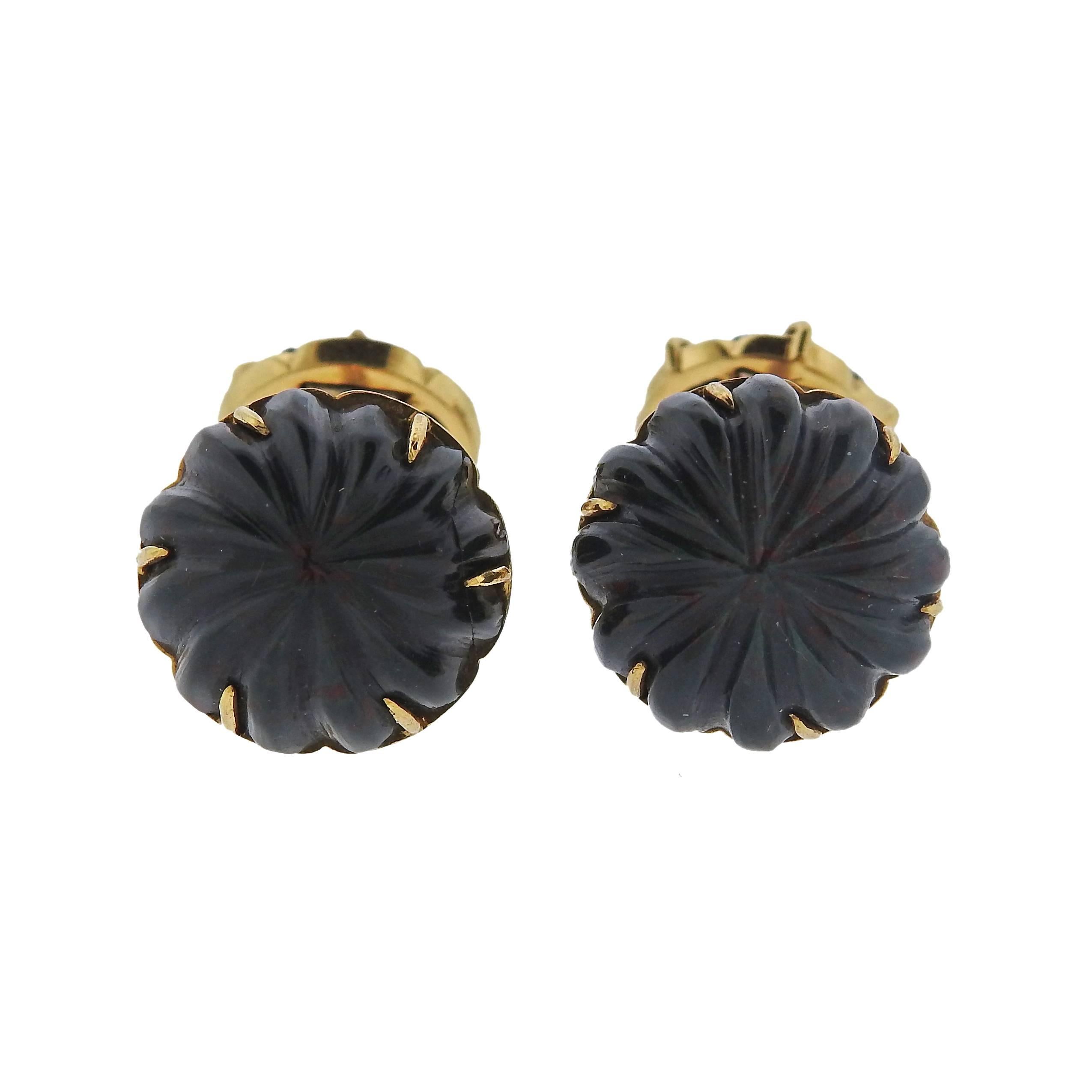Pair of 18k yellow gold cufflinks, crafted by Tiffany & Co in France, set with carved bloodstone. Cufflink top is 16mm in diameter, back - 12mm in diameter. Marked: France, 18k, Tiffany & Co. Weight - 15.5 grams 