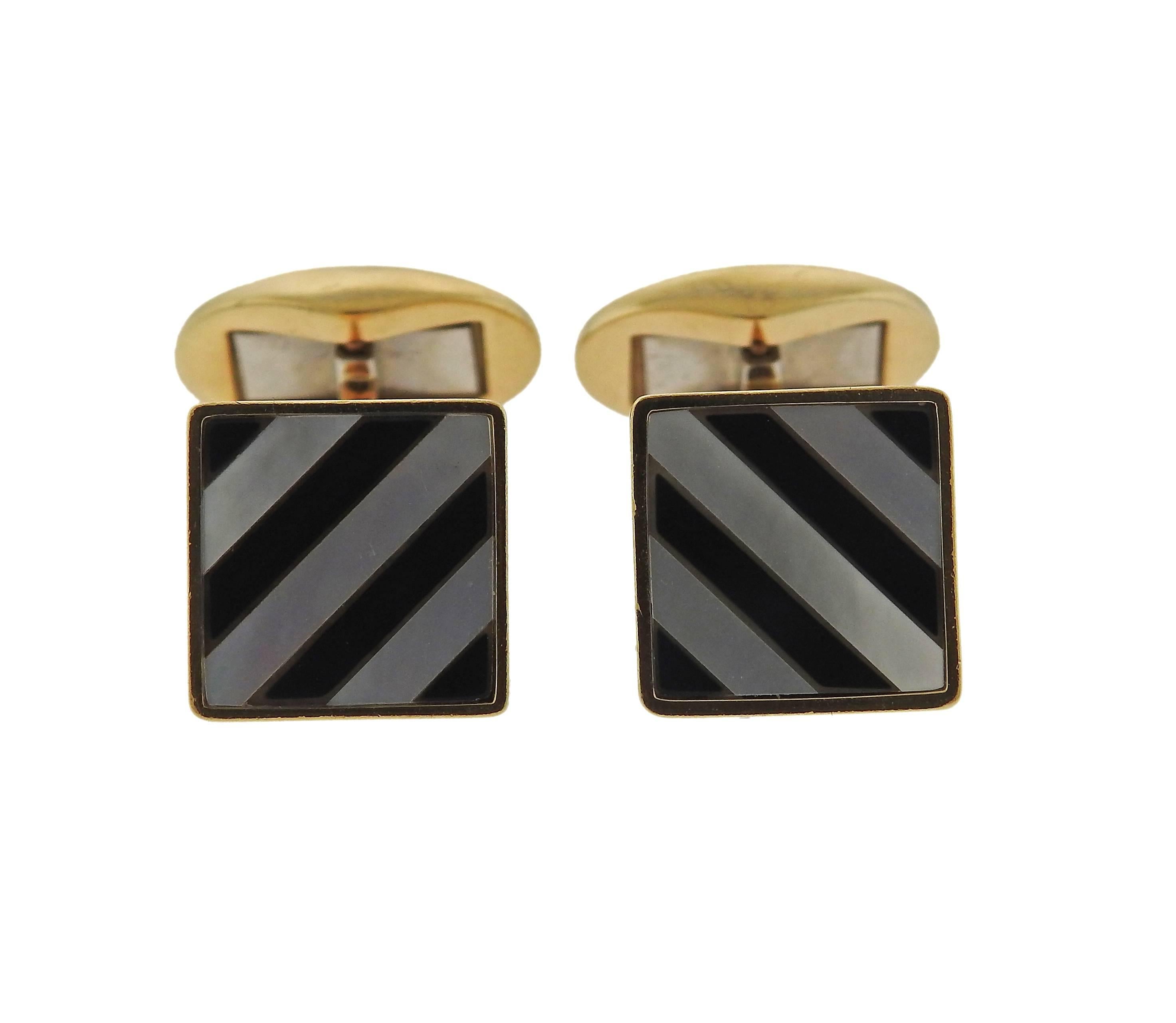 Pair of 18k yellow gold cufflinks, crafted by Tiffany & Co, decorated with onyx and mother of pearl inlay top. Each top measures 12.8mm x 12.8mm. Marked: Tiffany & Co, 18k, W-Germany. Weight - 14.7 grams