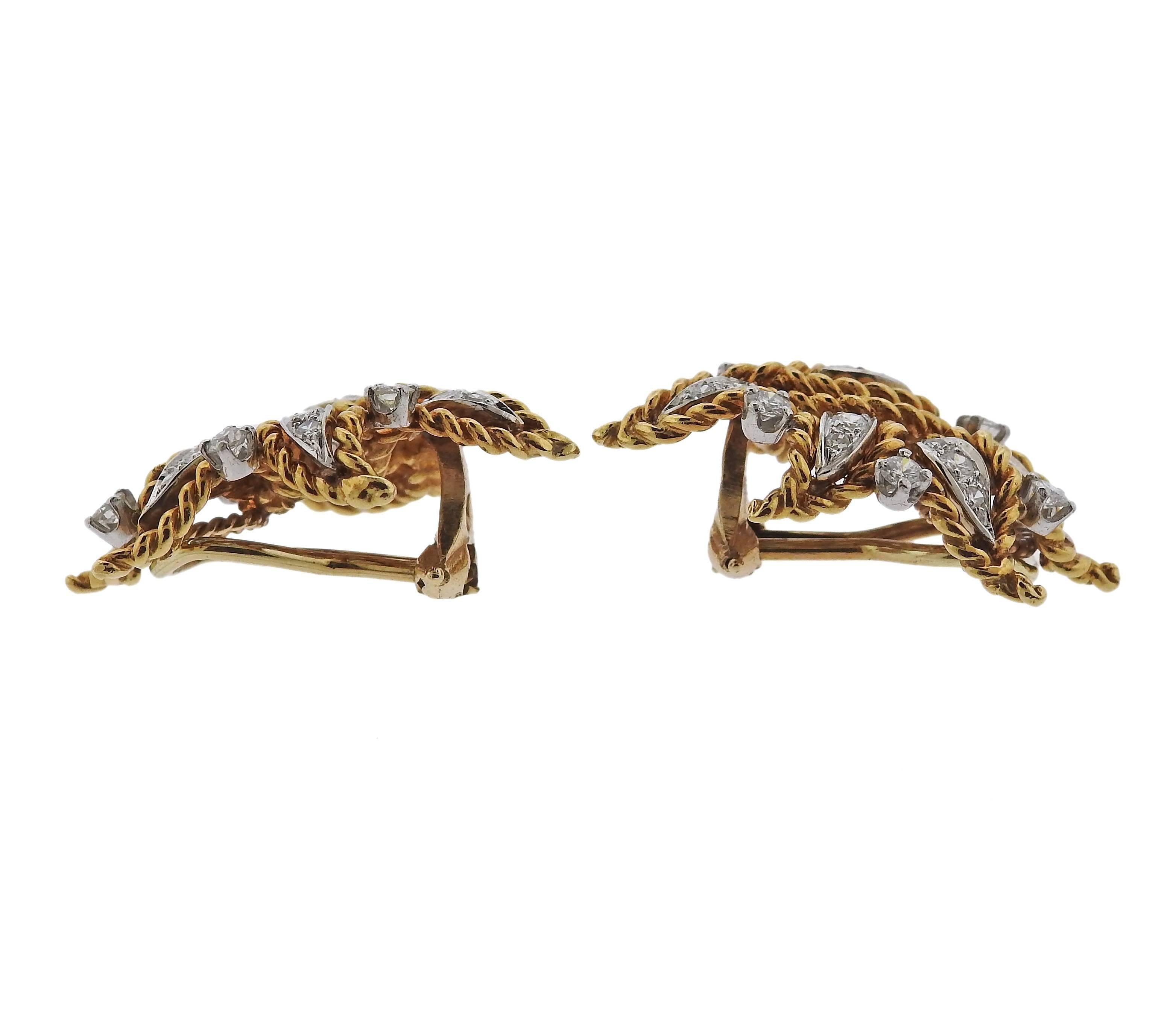 A pair of 18k gold earrings featuring approximately 1.10ctw of H/VS-SI1 diamonds. Earrings measure 30mm X 21mm. Marked PM tested 18k. Weight is 15 grams.