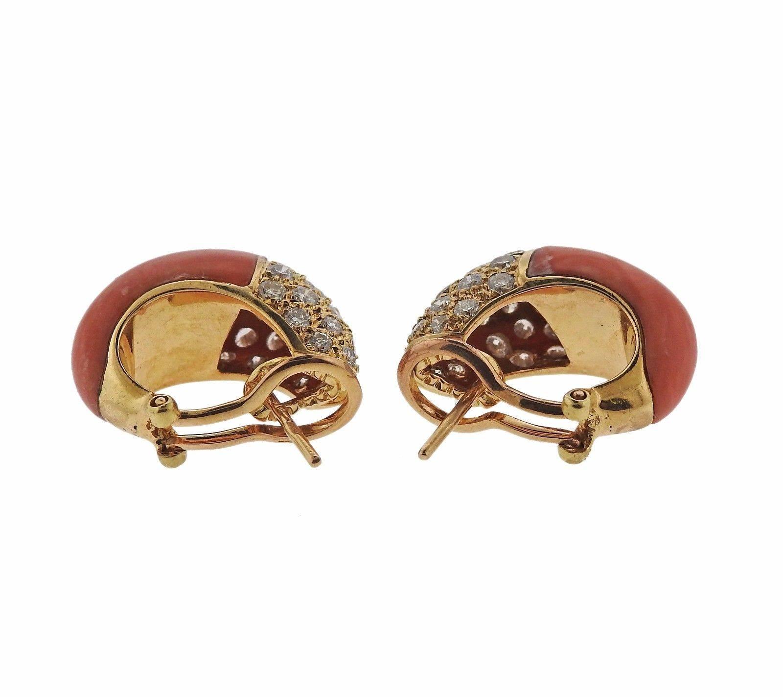 A pair of 18k yellow gold earrings set with coral and approximately 2.50ctw of VS-SI1/H diamonds.  The earrings measure 23mm x 10mm and weigh 16.7 grams.