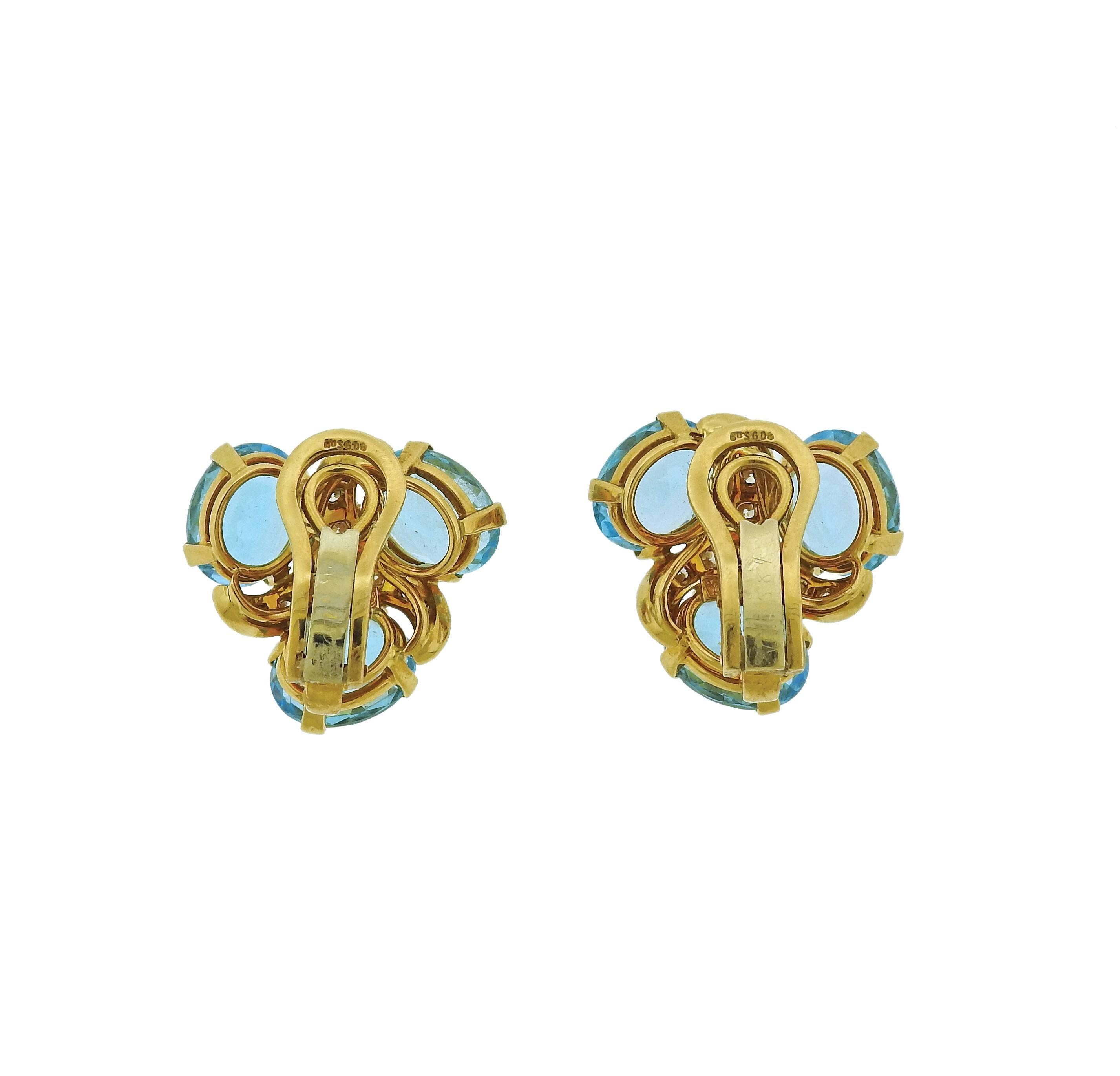 Pair of 18k yellow gold earrings, crafted by Verdura, decorated with blue topaz and approximately 0.90ctw in G/VS diamonds. Earrings are 21mm x 21mm  and weigh 16.9 grams. Marked: Verdura 750, 1077HI