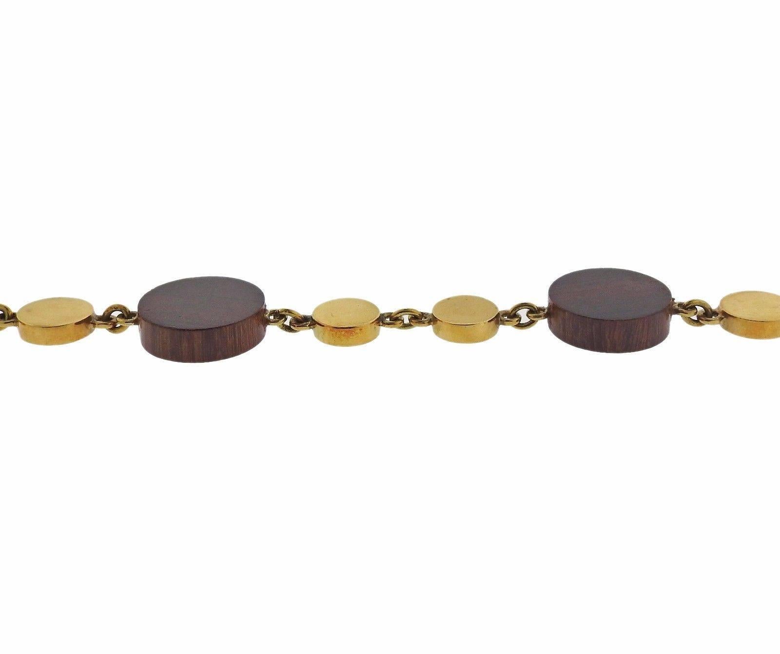 An 18k yellow gold bracelet with ebony wood stations.  The bracelet measures 7 1/2" long and the ebony circles are 18mm in diameter. The weight of the piece is 14.8 grams. Marked: 750.