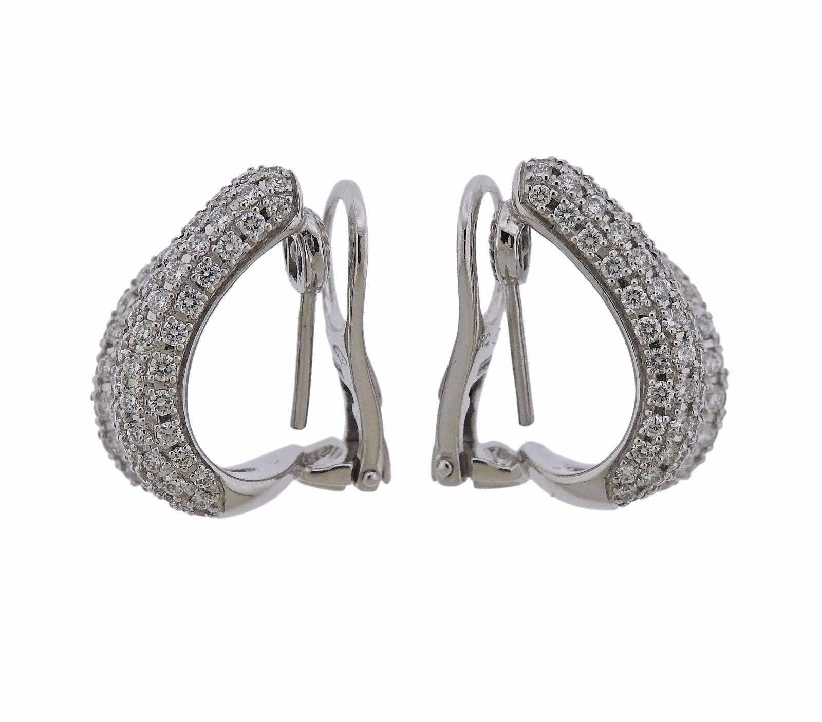A pair of 18k white gold earrings set with approximately 1.80ctw of G/VS diamonds.  The earrings measure 20mm x 10mm and weigh 12.9 grams. Marked: Signature ruby, RC, 750, 1226VI 12.9 grams.